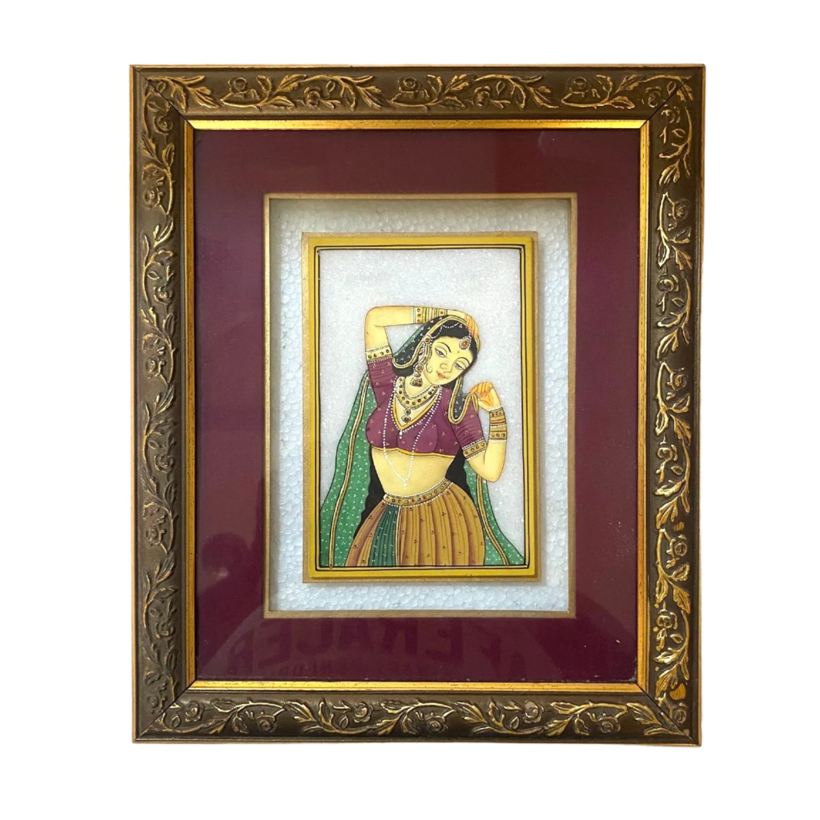 Framed artwork of a woman in traditional attire on a white wall