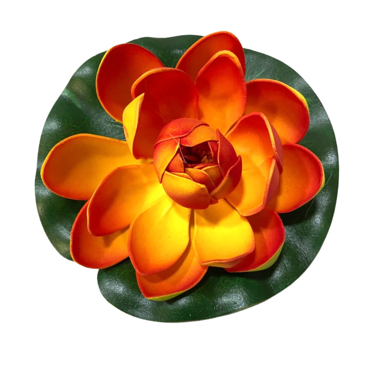 Artificial orange and yellow flower on a green leaf with a white background