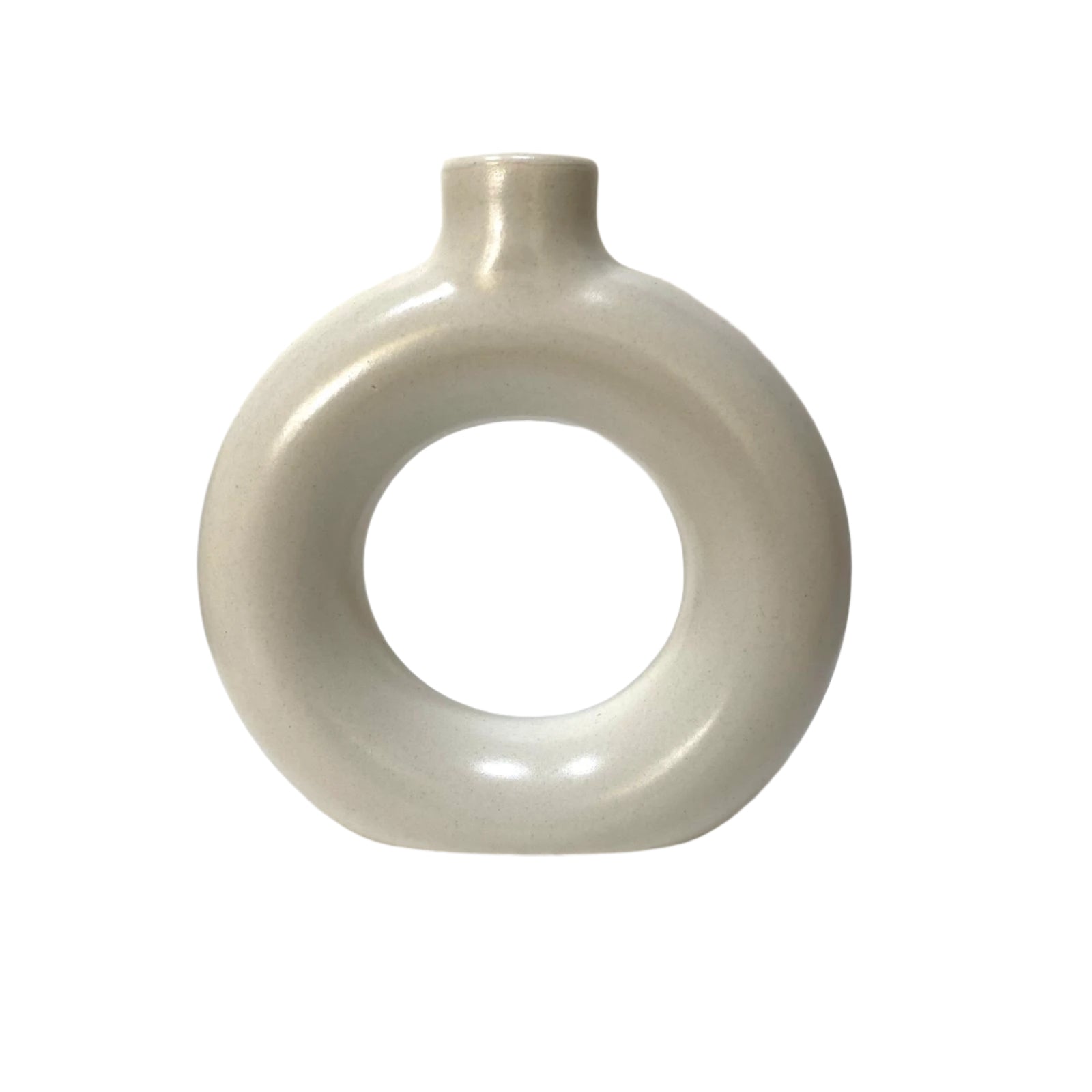 White ceramic vase with circular design on a textured white surface