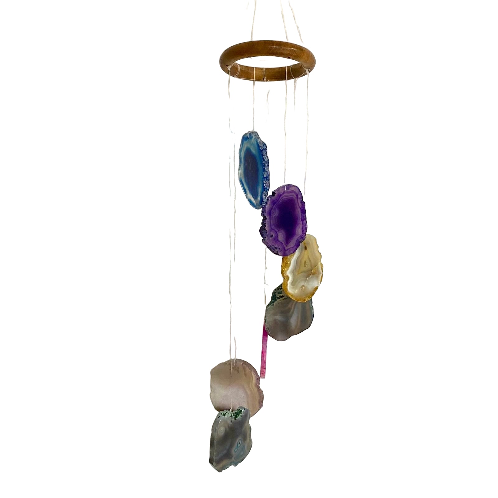 Decorative hanging with colorful stones on a textured white wall