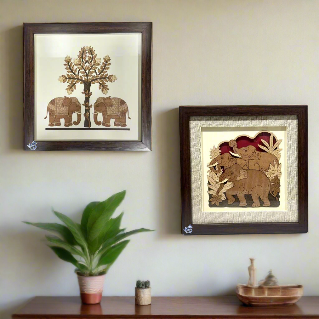 Two framed wall art pieces with elephants and trees on a white background