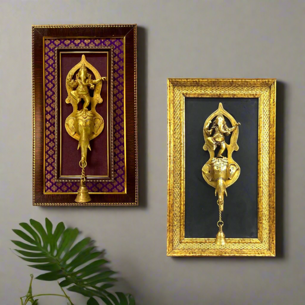 Two decorative wall hangings with gold figures in ornate frames on a white background