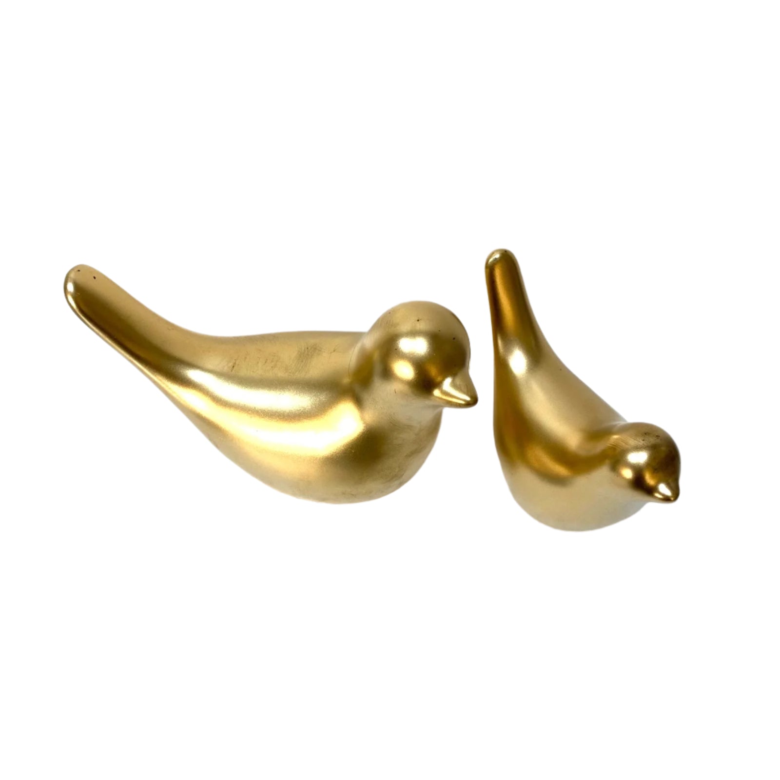 Two gold bird-shaped objects on a white surface