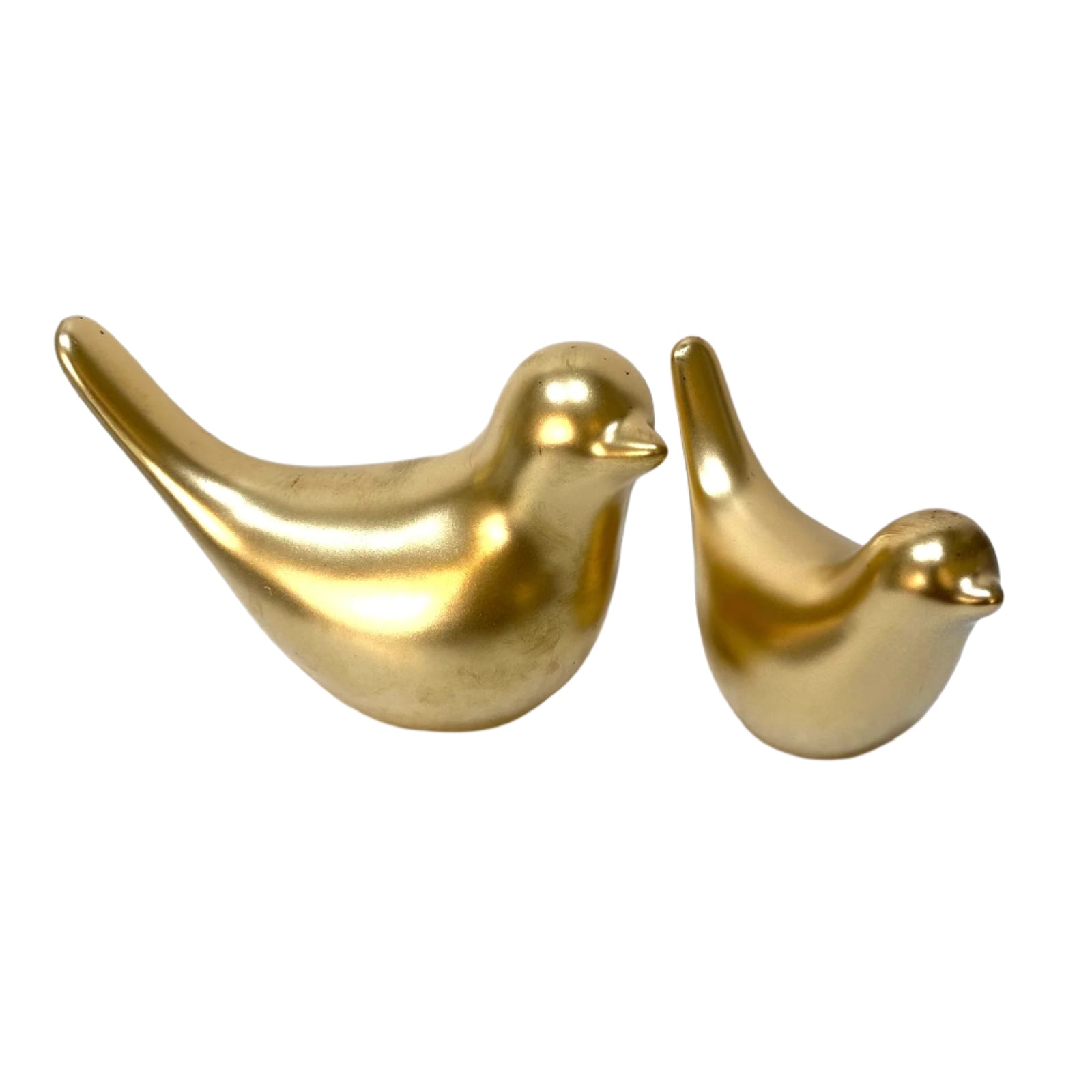 Two gold bird-shaped objects on a white surface with a white background