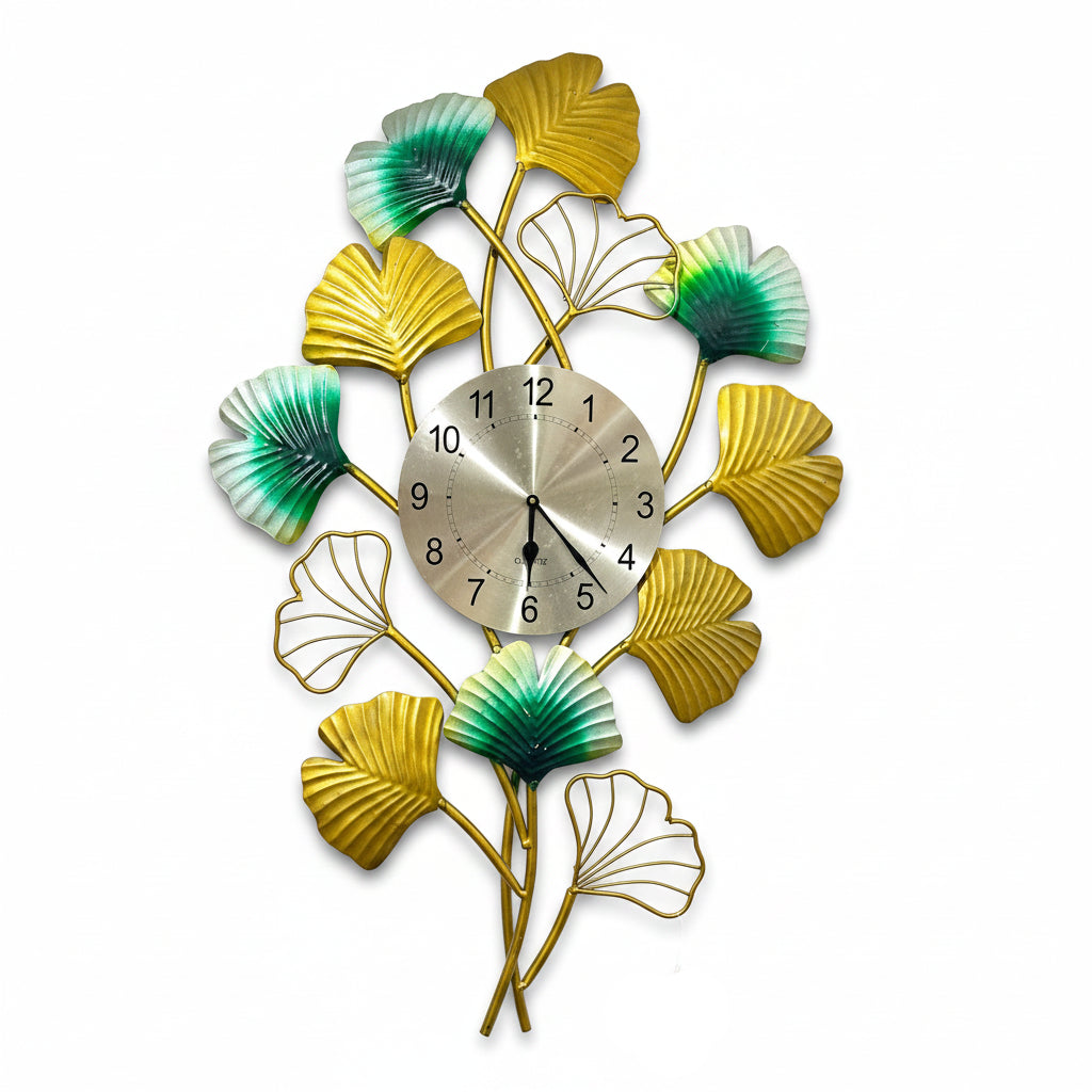 Decorative wall clock with leaf designs on a white wall.