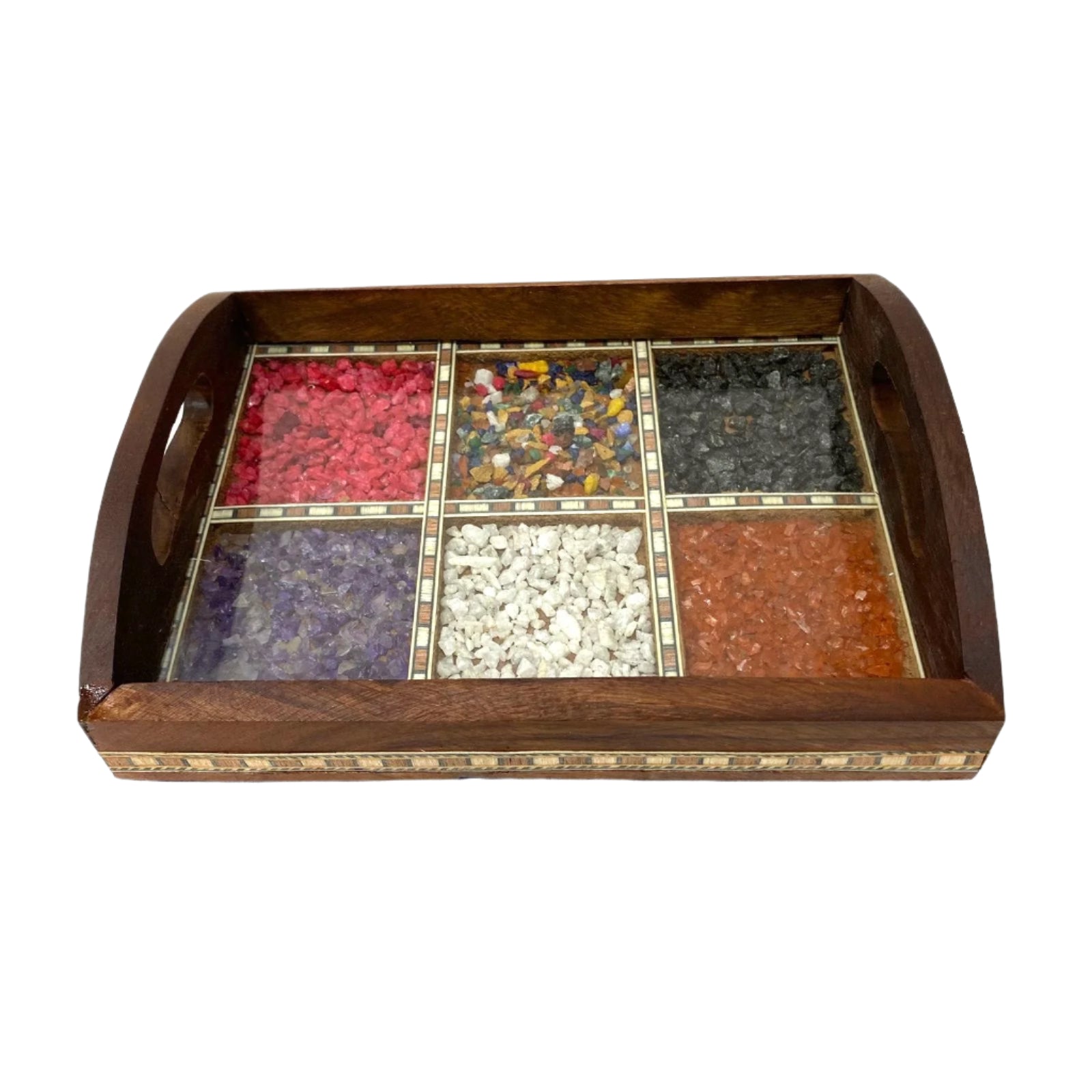 Wooden tray with six compartments filled with different colored stones on a white surface.