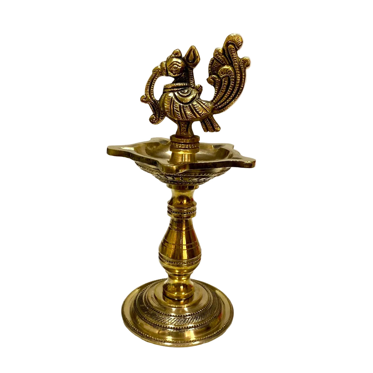 An ornate brass oil lamp with a decorative elephant figurine on top, set against a plain white background.