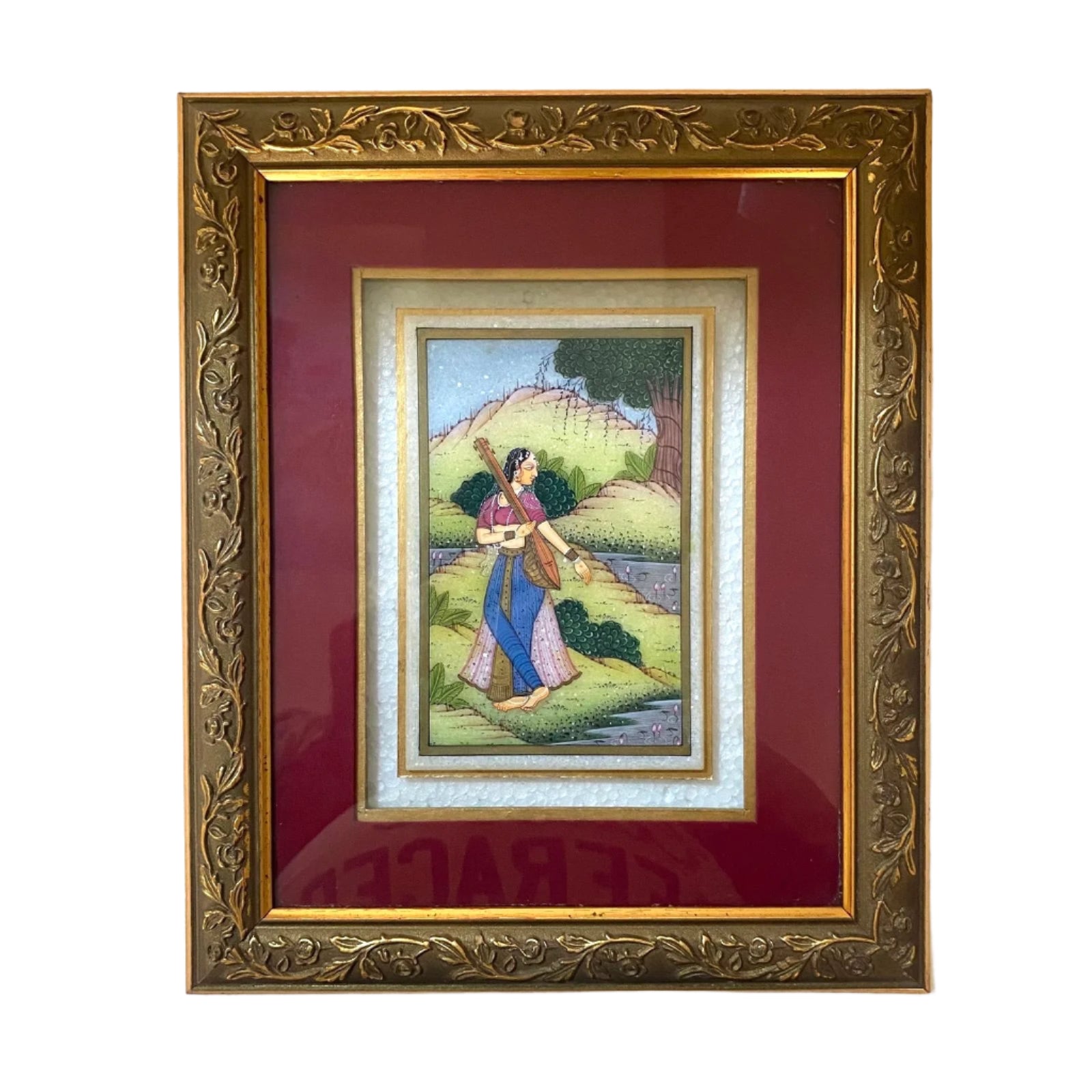 Framed artwork of a woman in a garden with a decorative gold frame.