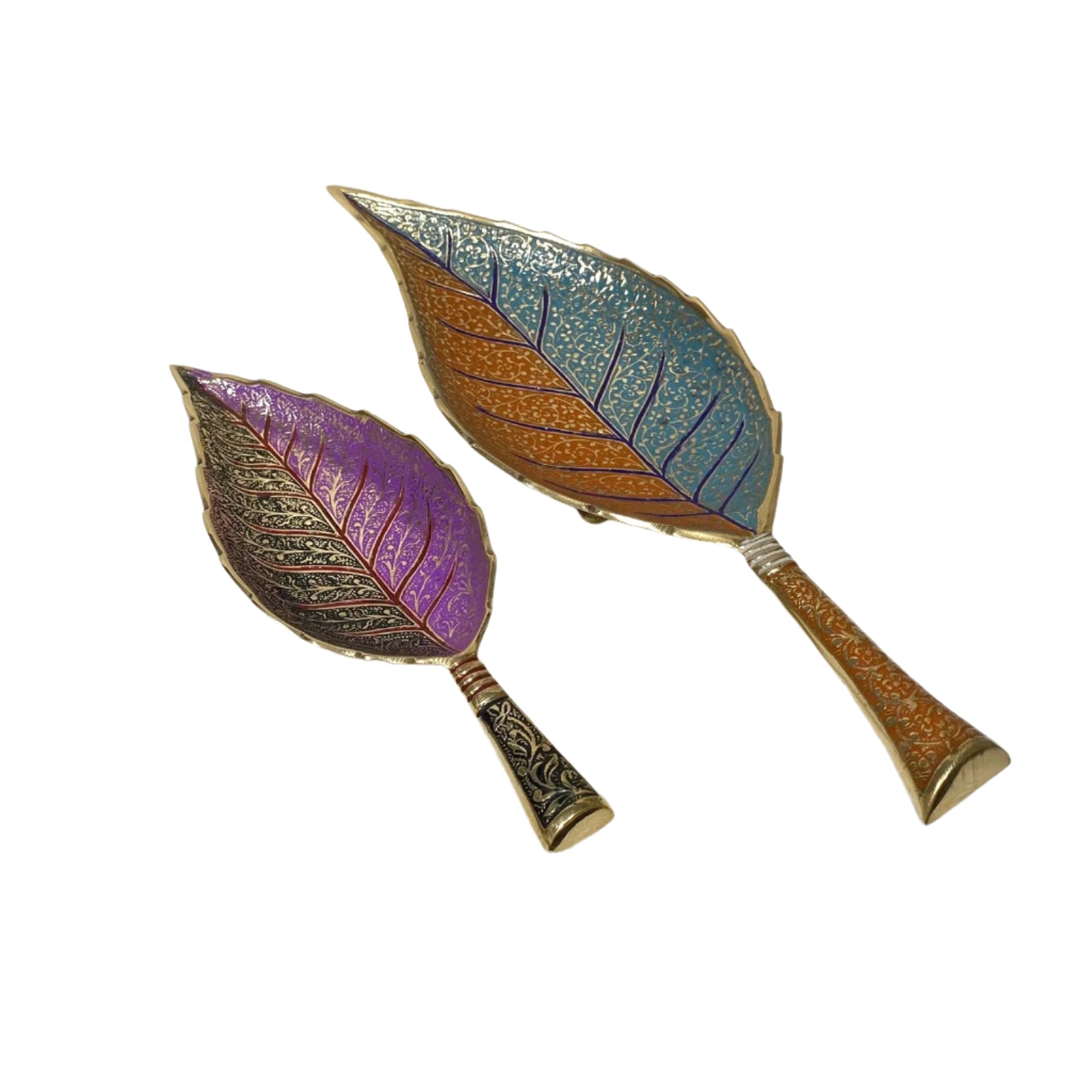 Two leaf-shaped hand mirrors with colorful finishes on a white textured surface.