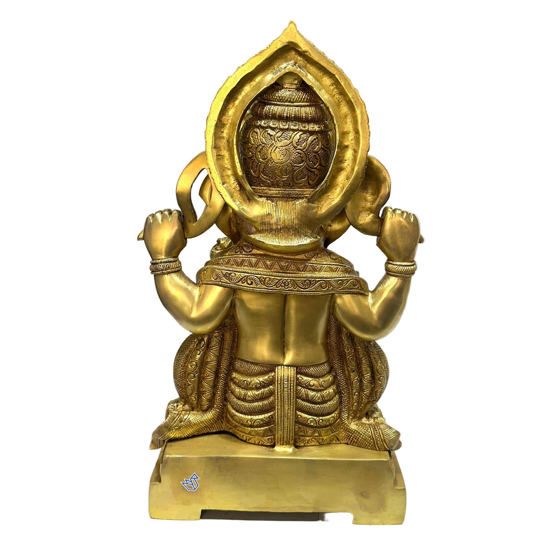 Gold-colored statue or sculpture on a white surface with a blurred background