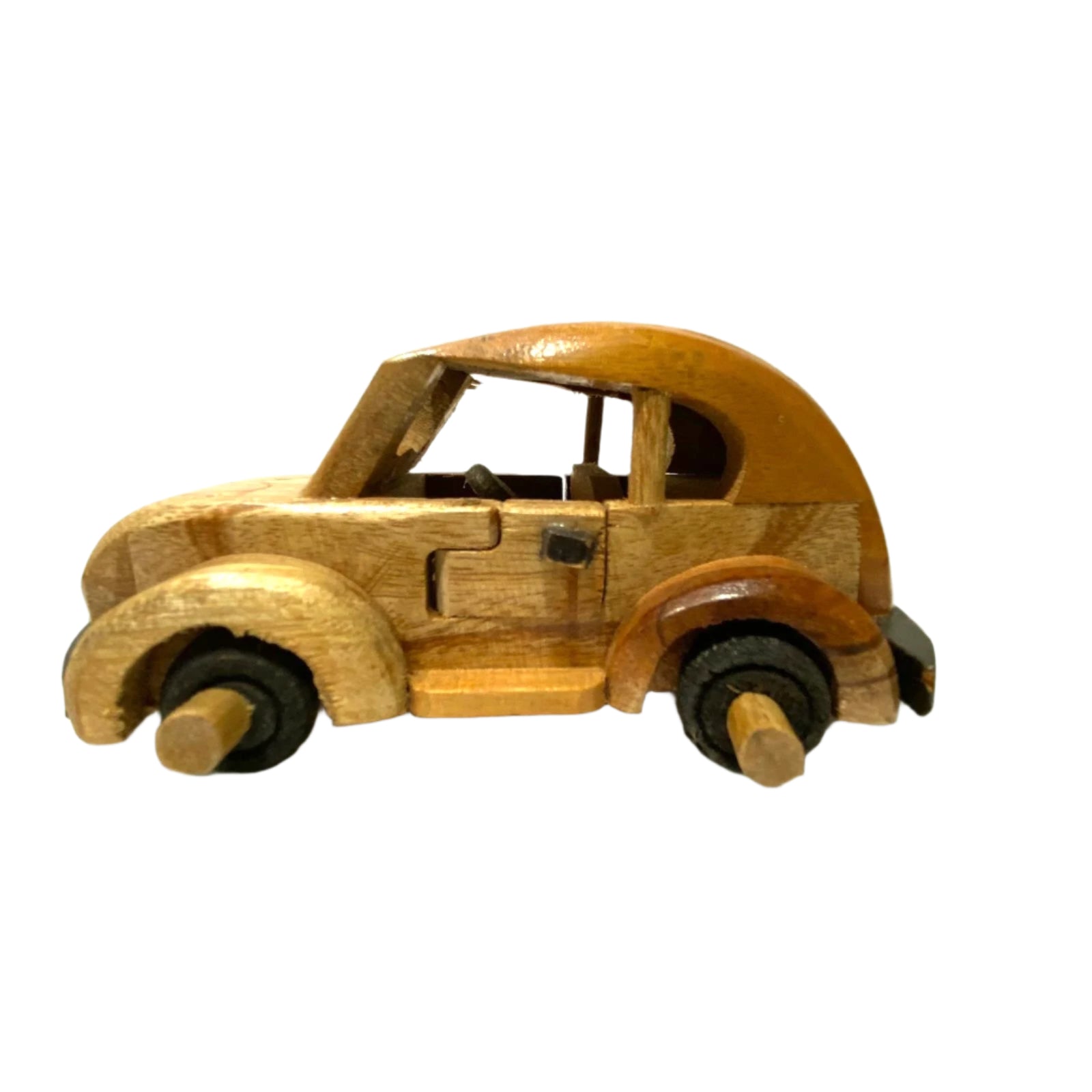 Wooden toy car on a white surface with a light background
