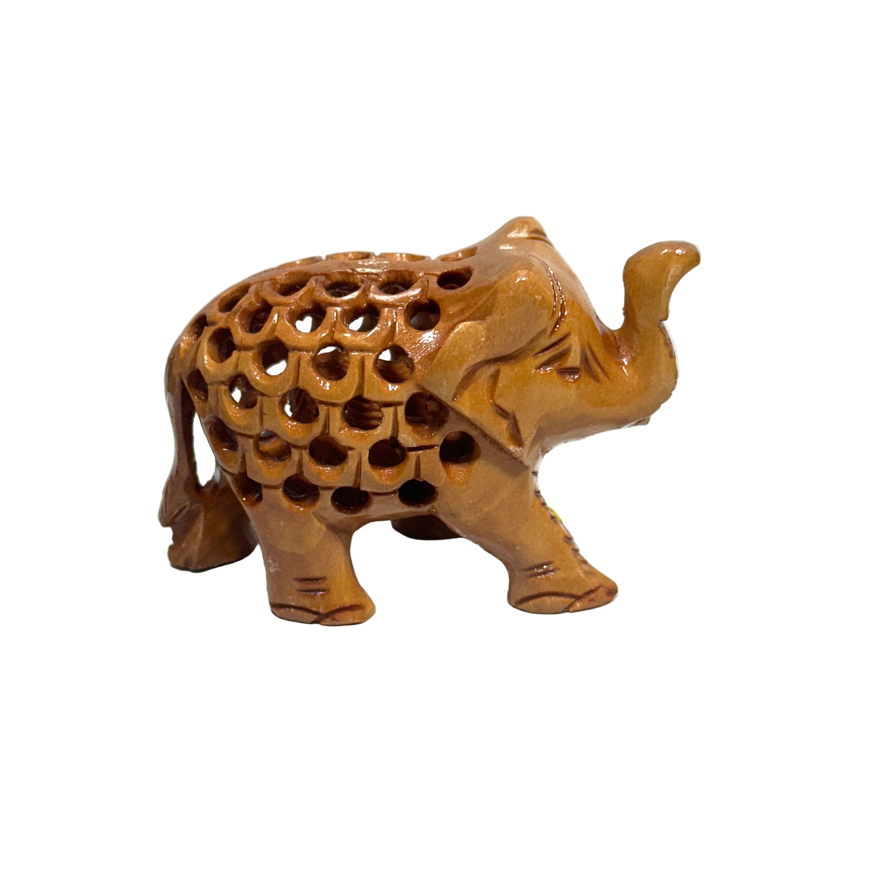 Wooden elephant figurine with intricate carvings on a white background
