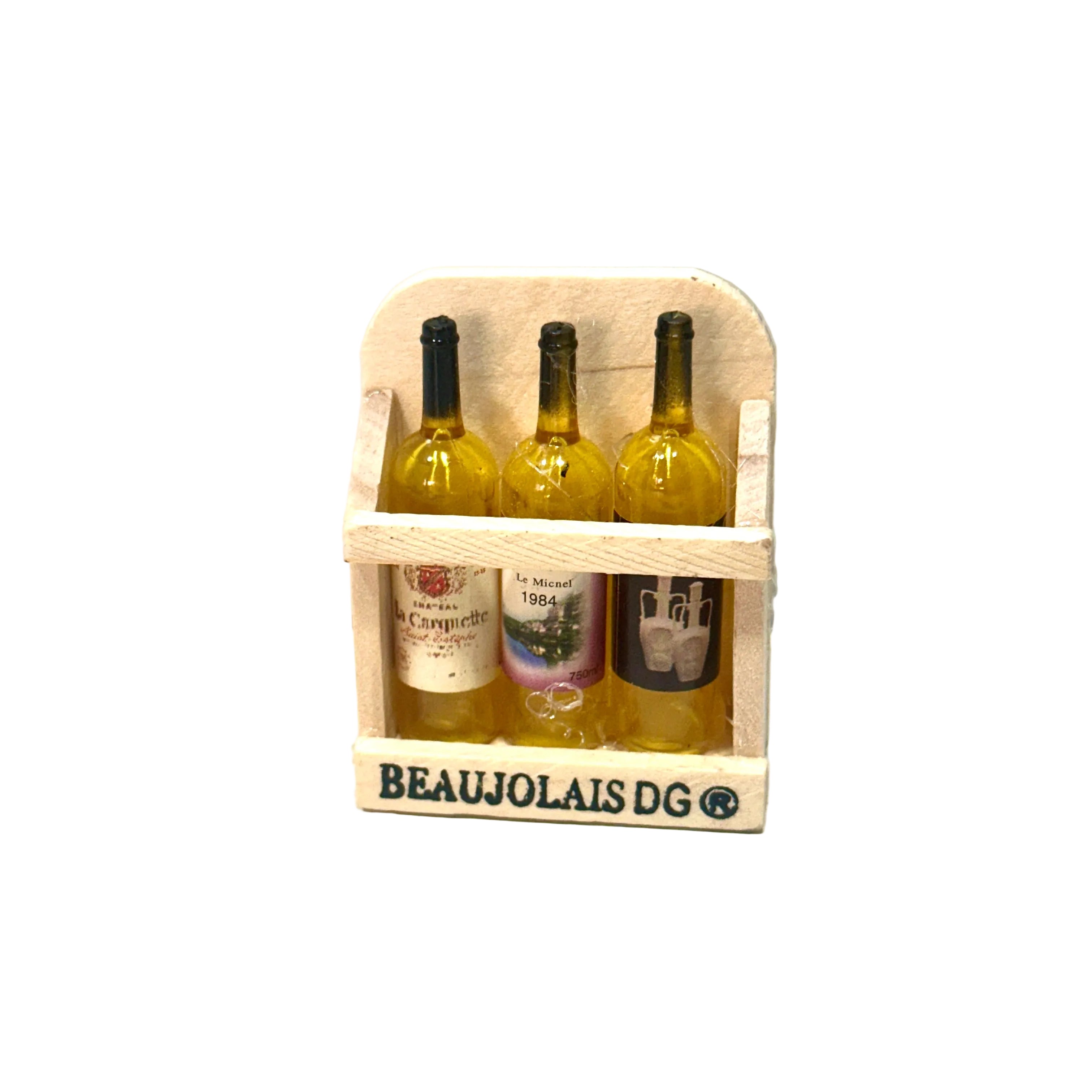 Three bottles of Beaujolais wine in a wooden crate on a white surface with a light gray background.