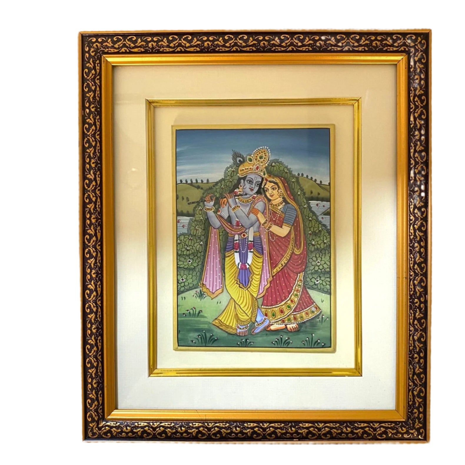 Framed artwork of two figures in traditional attire on a white wall.
