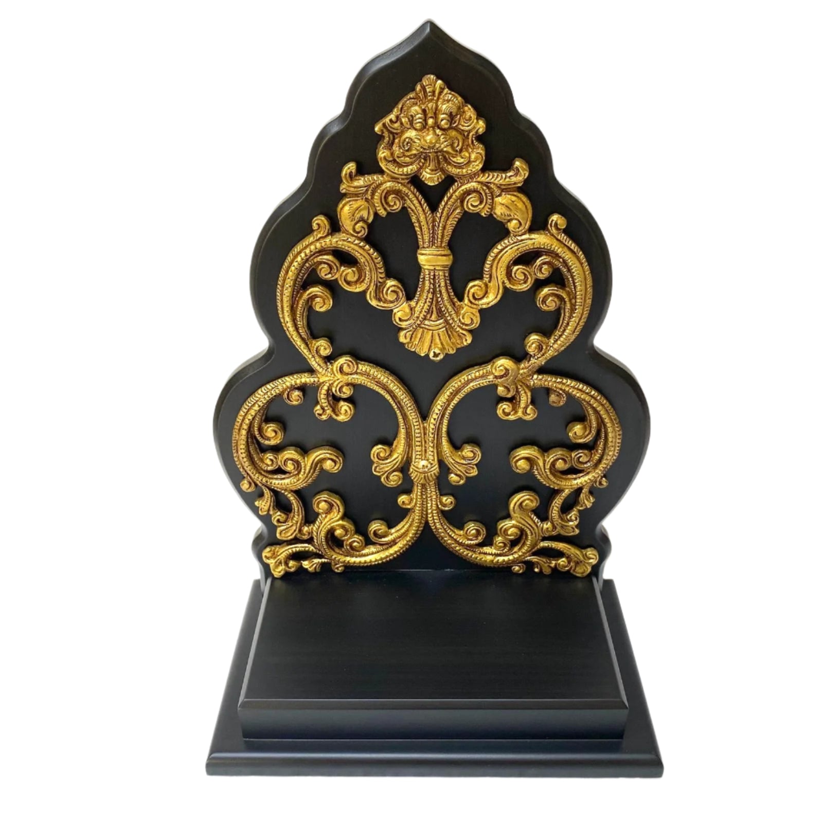 Decorative black and gold ornate object on a white background