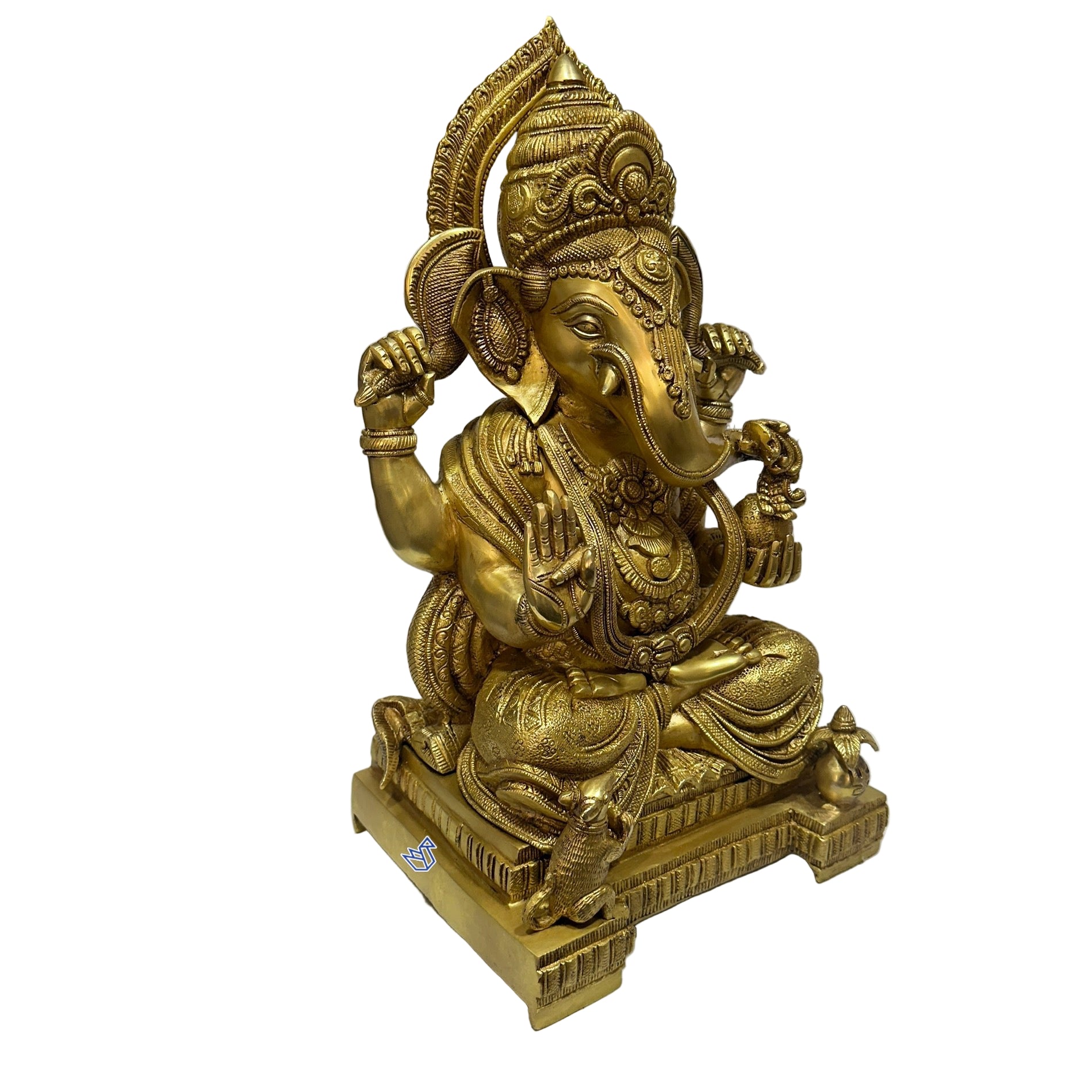 Gold-colored statue of a deity on a white surface with a blurred background