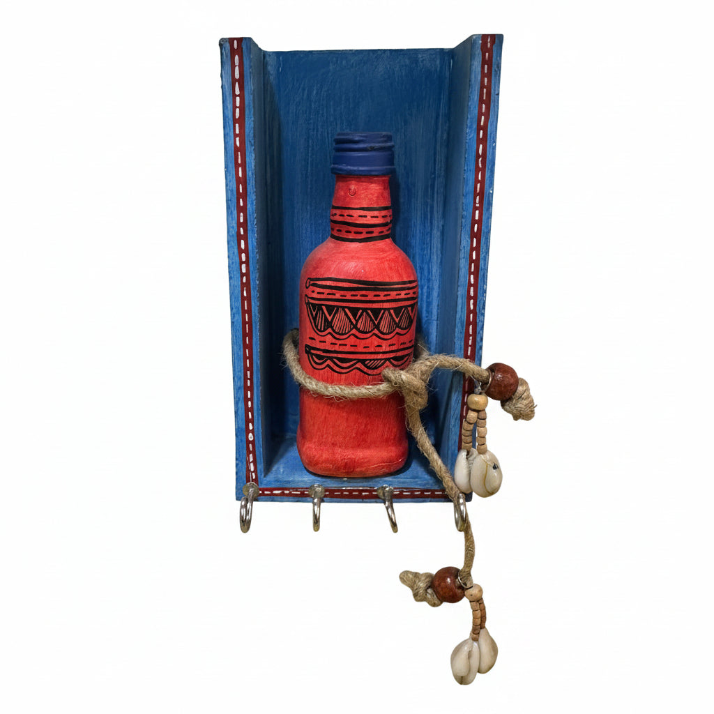 Decorative red bottle with blue top in a wooden shelf with hooks on a white wall.