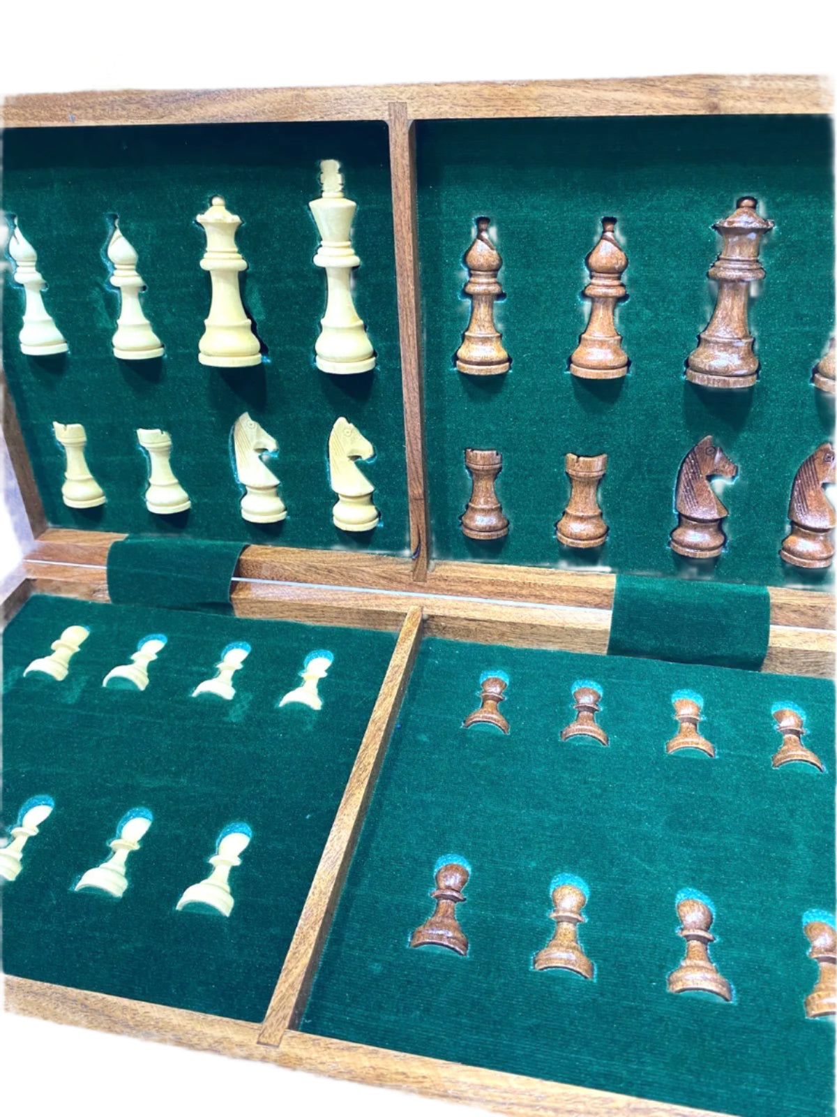 Chess pieces in a wooden box with green felt