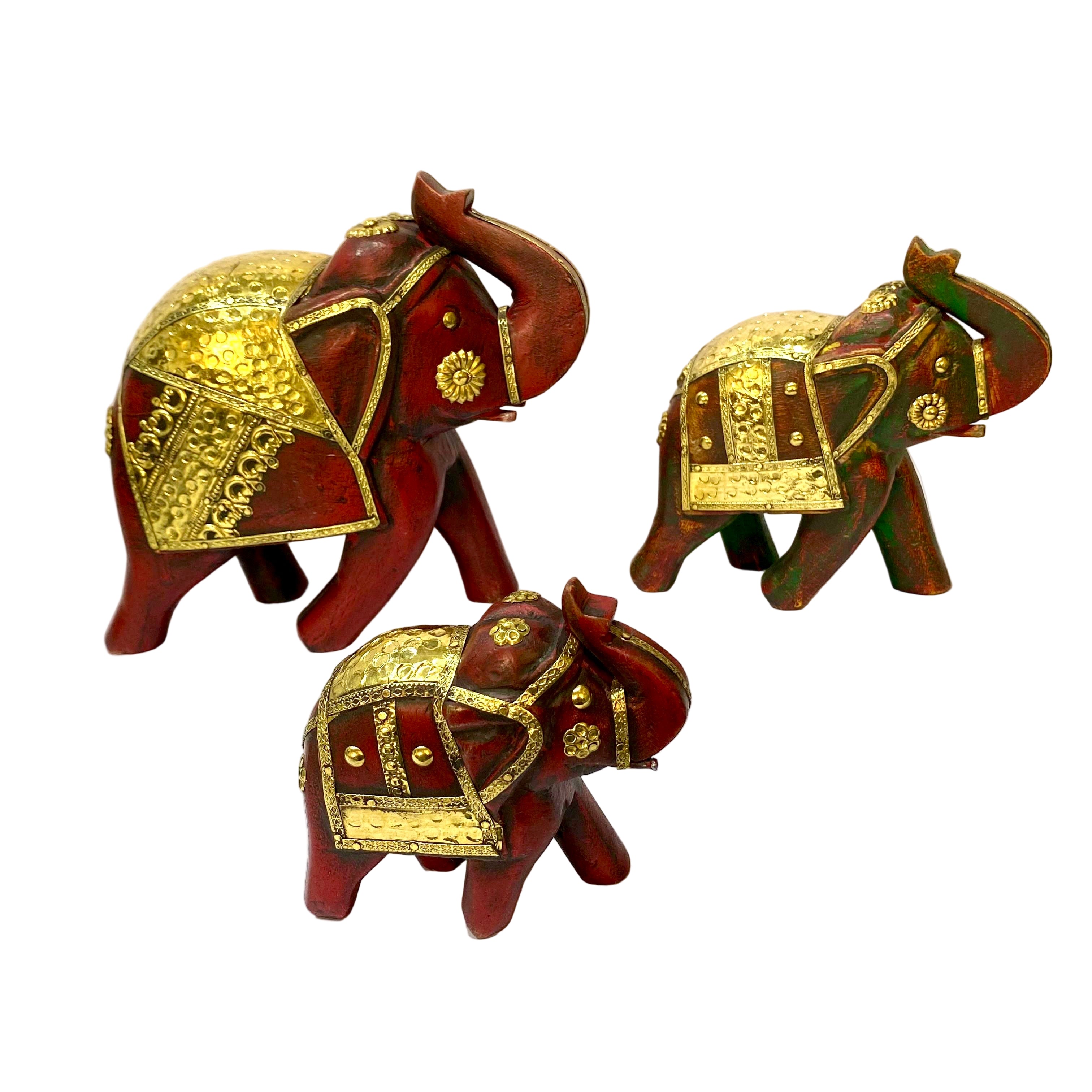 Three decorative elephant figurines with gold accents on a white surface.