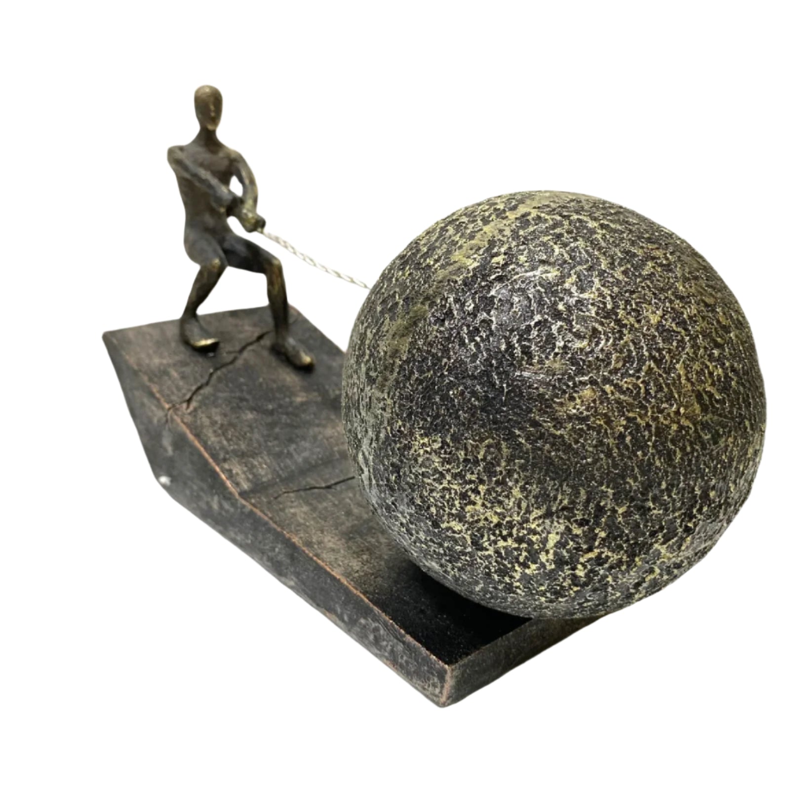 Bronze sculpture of a figure pulling a large ball on a flat surface