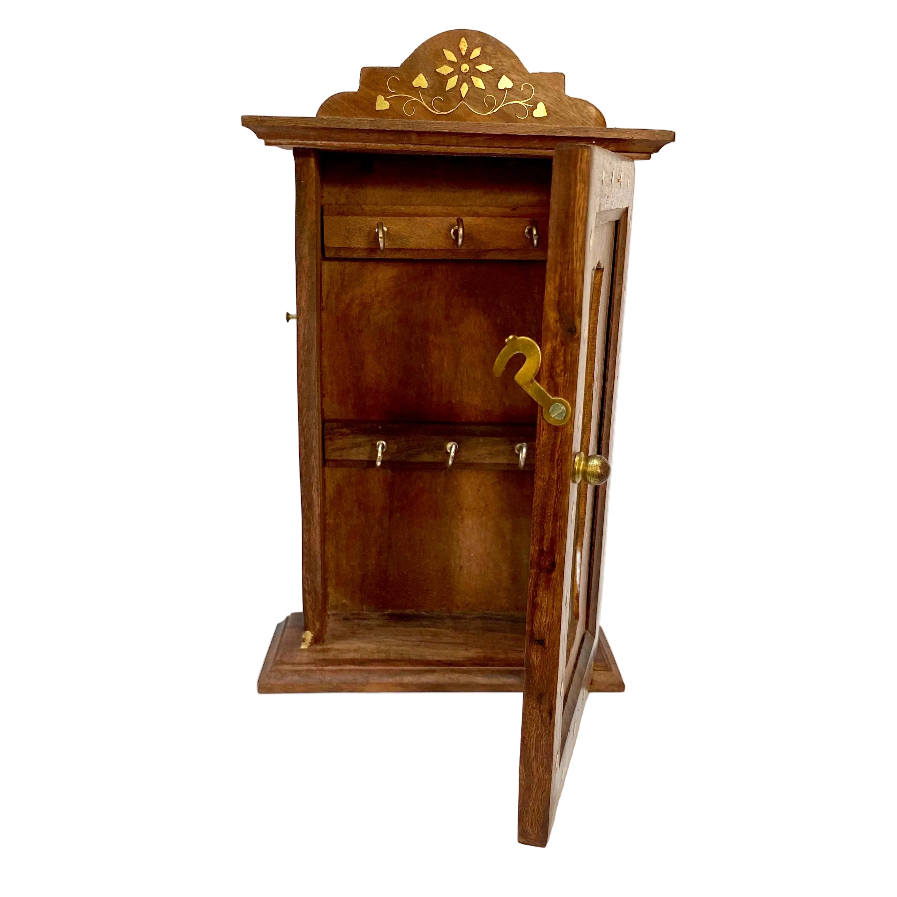 Wooden cabinet with decorative top and hooks on a white background