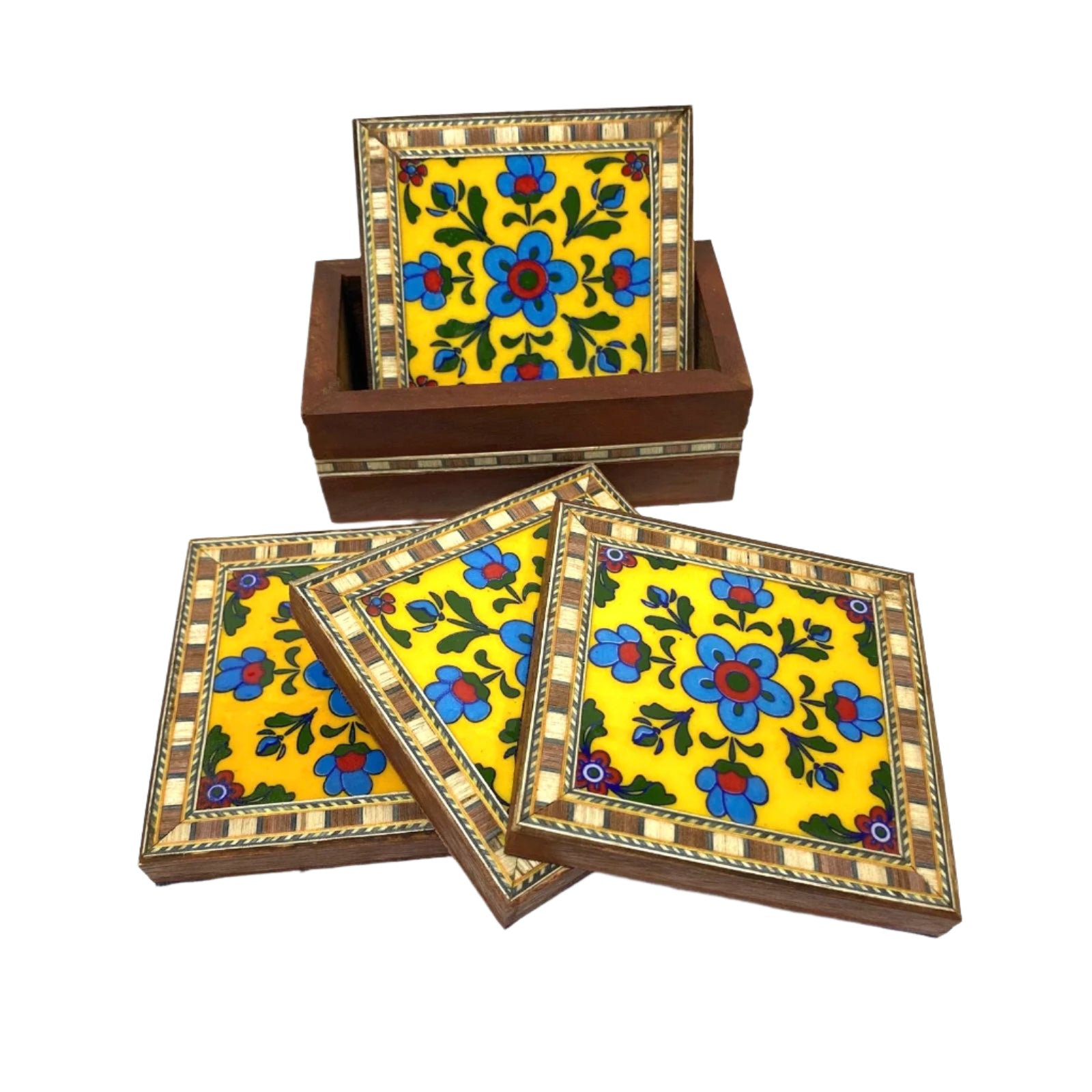 Set of four floral coasters with a wooden box on a white background