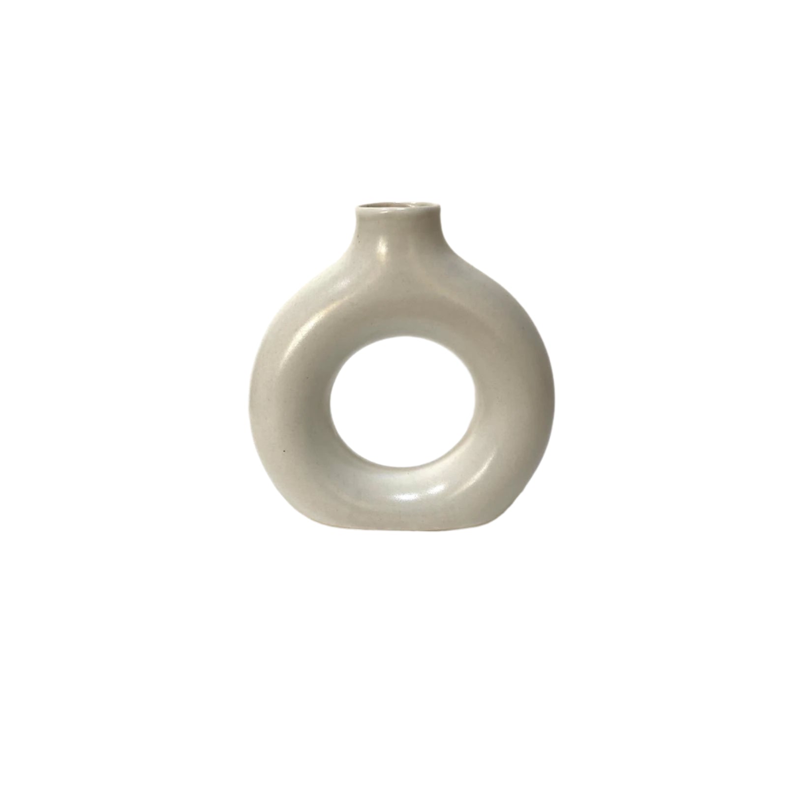 White ceramic vase with circular design on a white surface