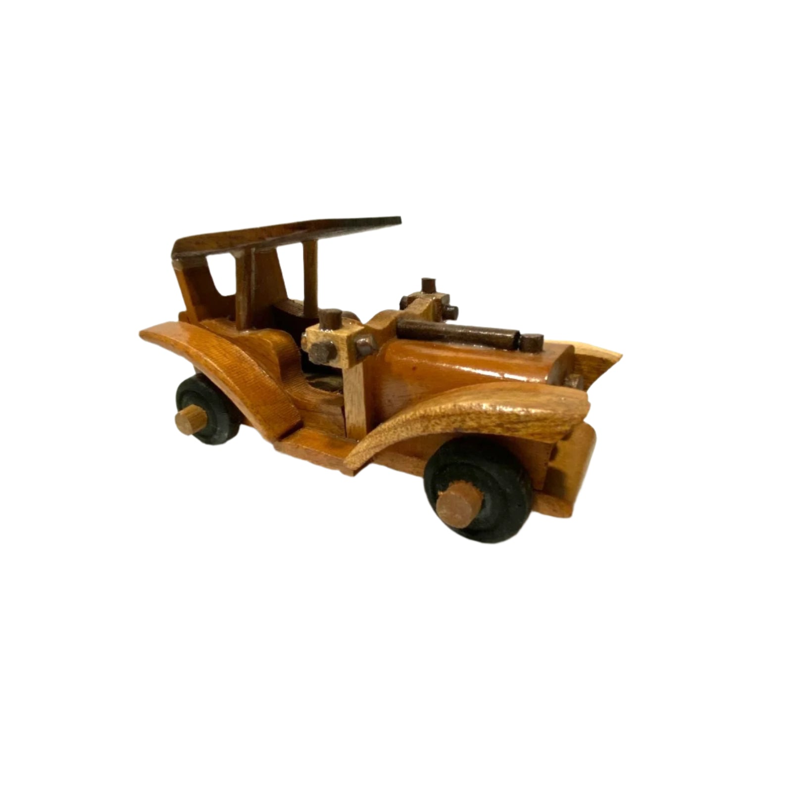 Wooden toy car on a white surface with a white wall background