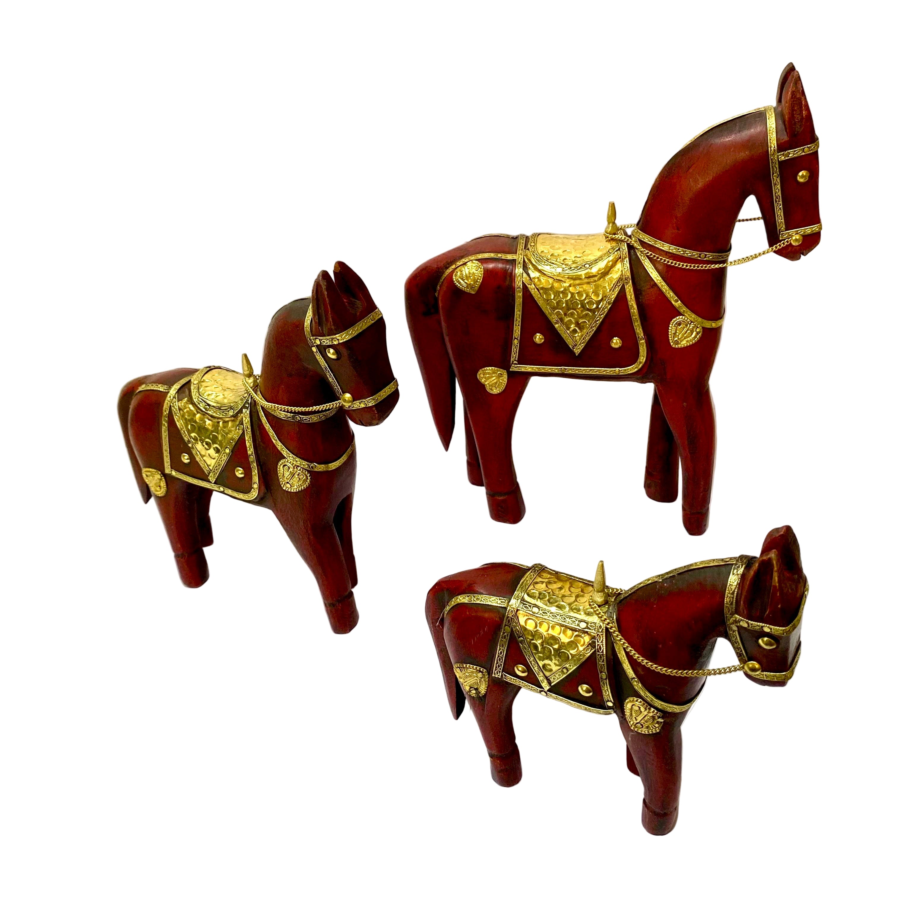 Three decorative wooden horses with gold accents on a white background