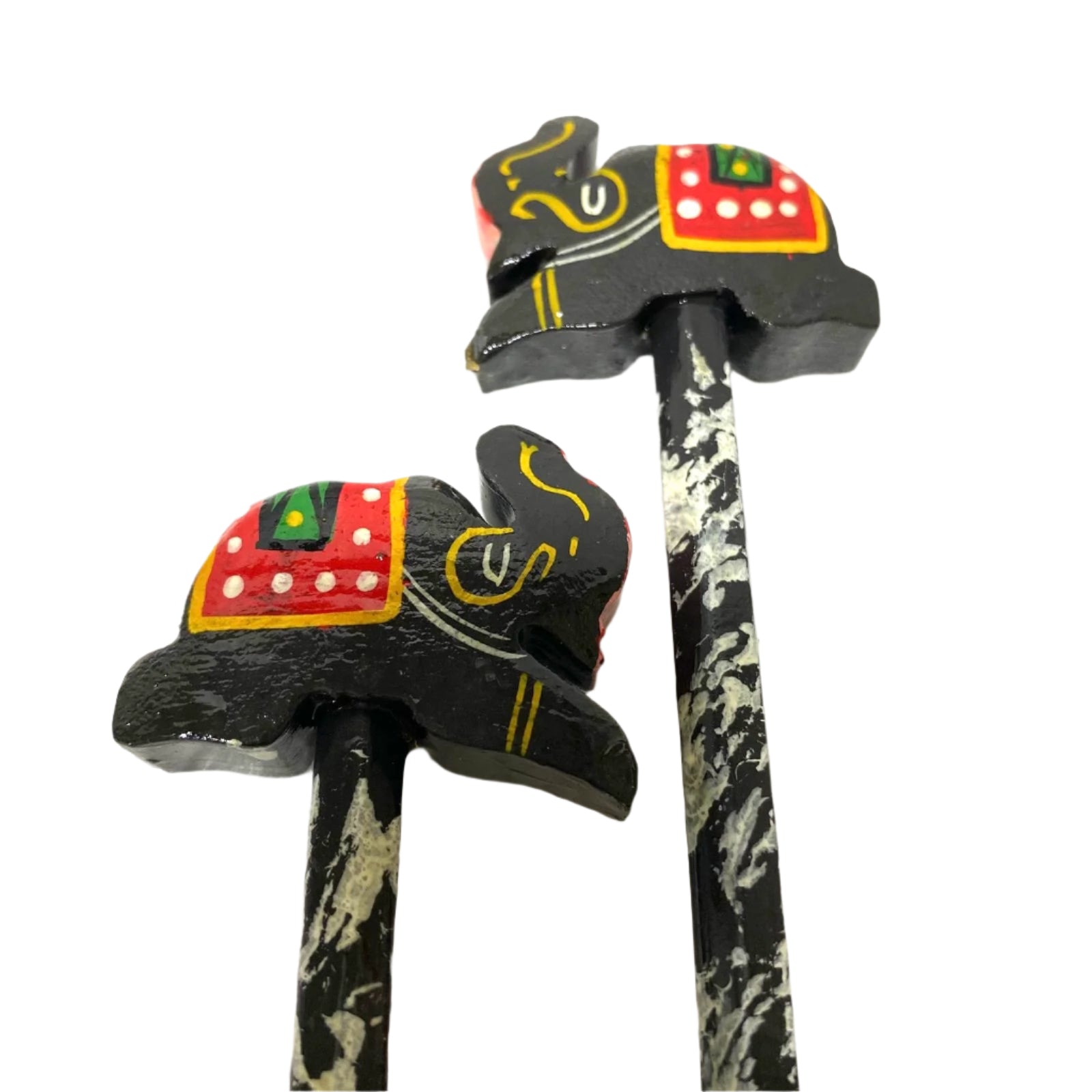 Two wooden elephant toys with colorful saddles on a white background