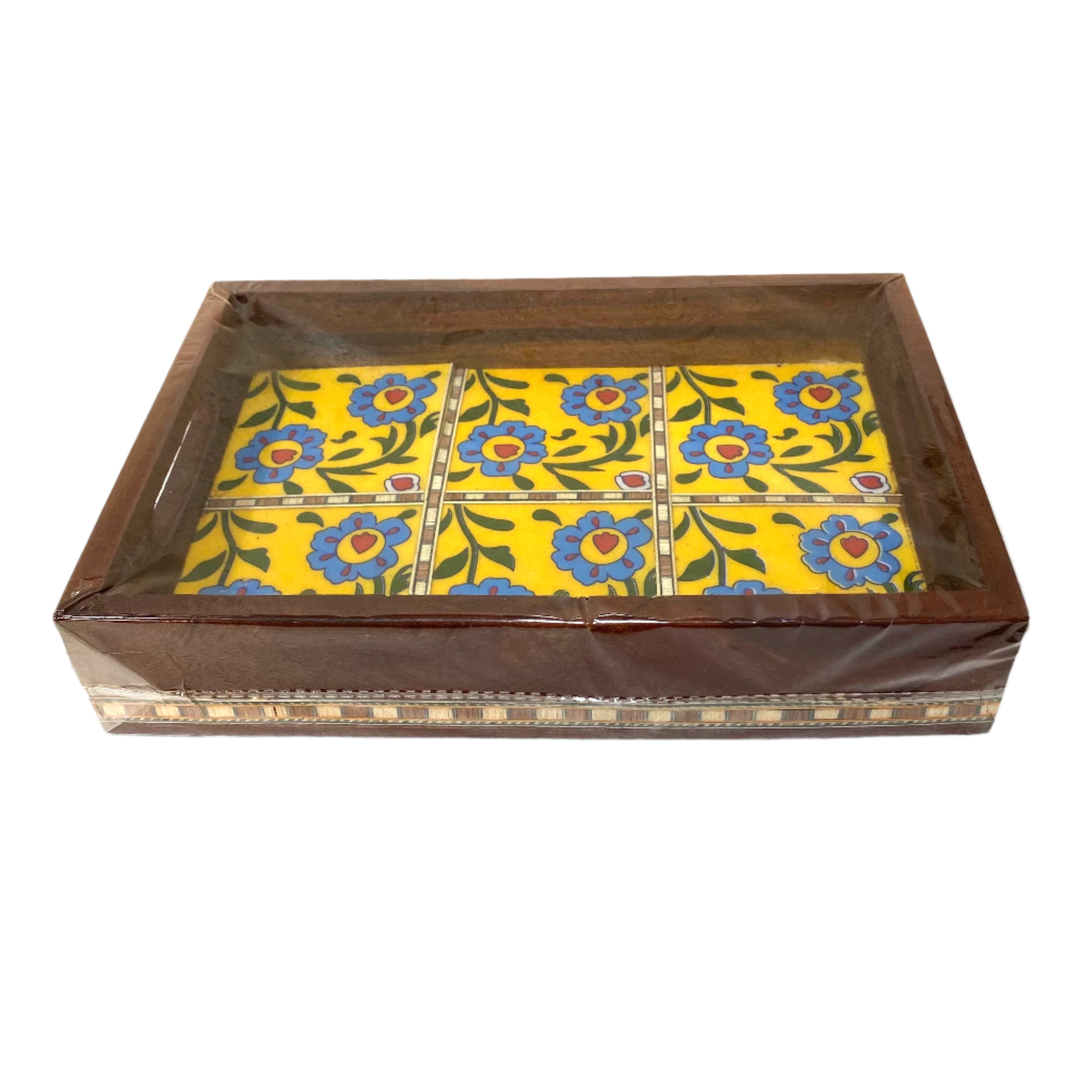 Decorative box with floral design on a yellow background