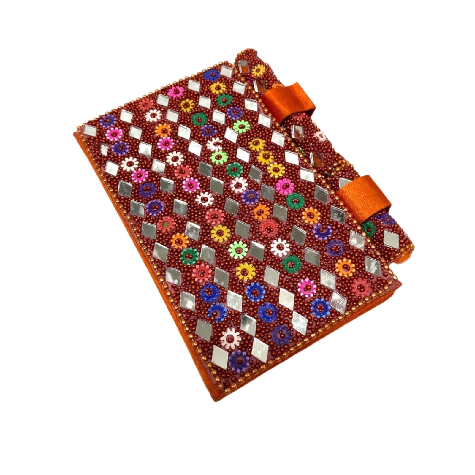 Decorative notebook with floral patterns and orange ribbons on a white background