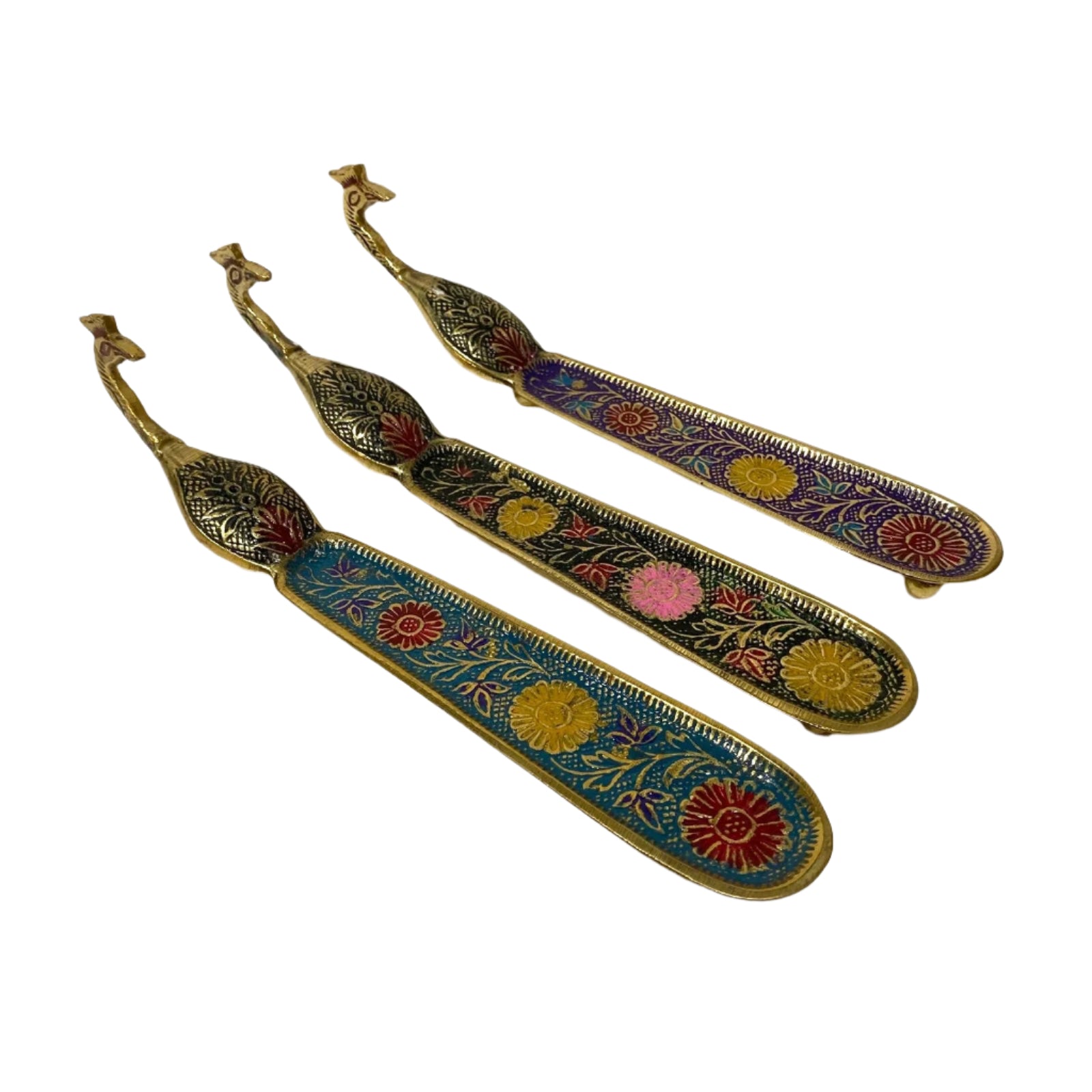 Decorative metal tools with floral patterns on a textured white surface