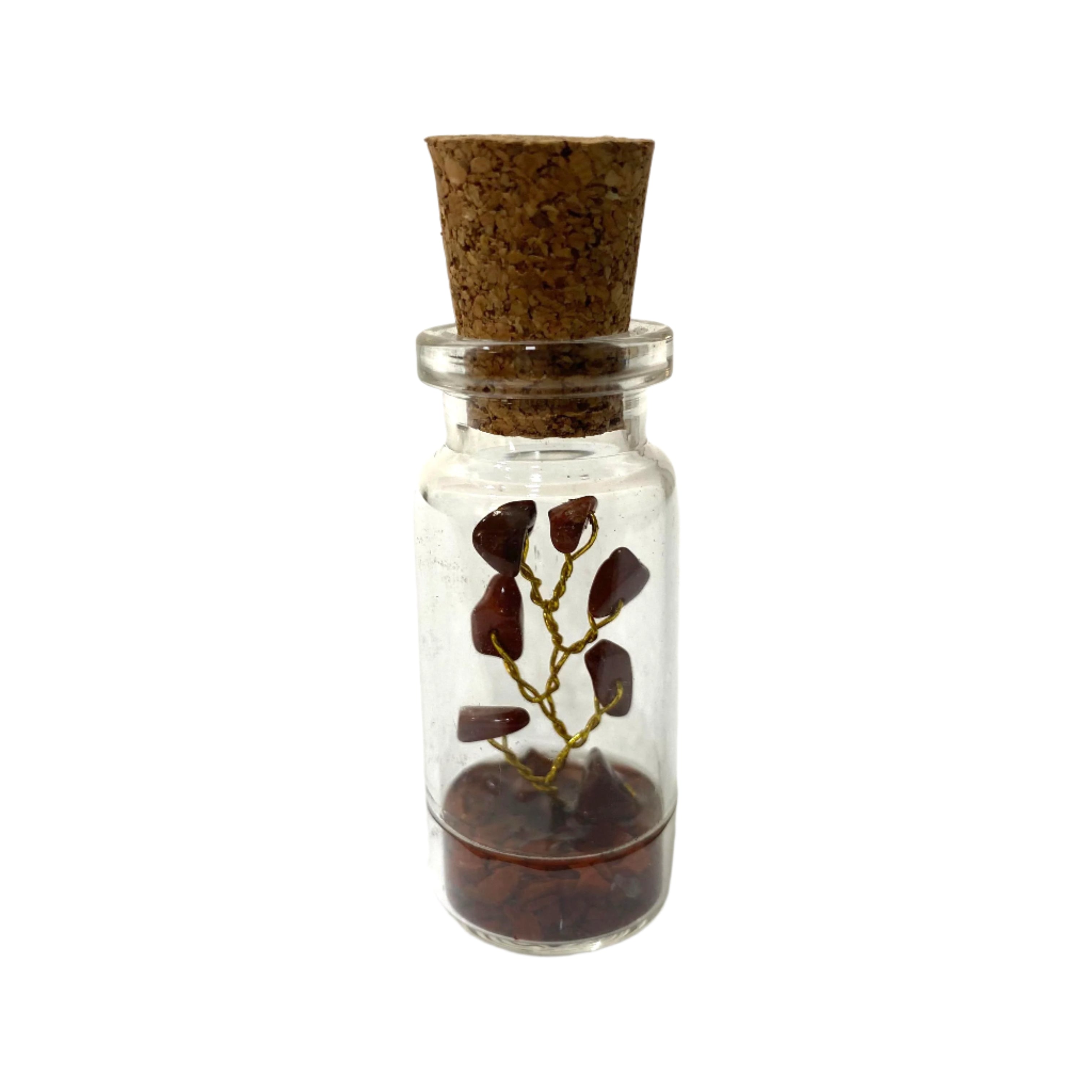 Small glass bottle with cork lid containing a branch and soil on a white background