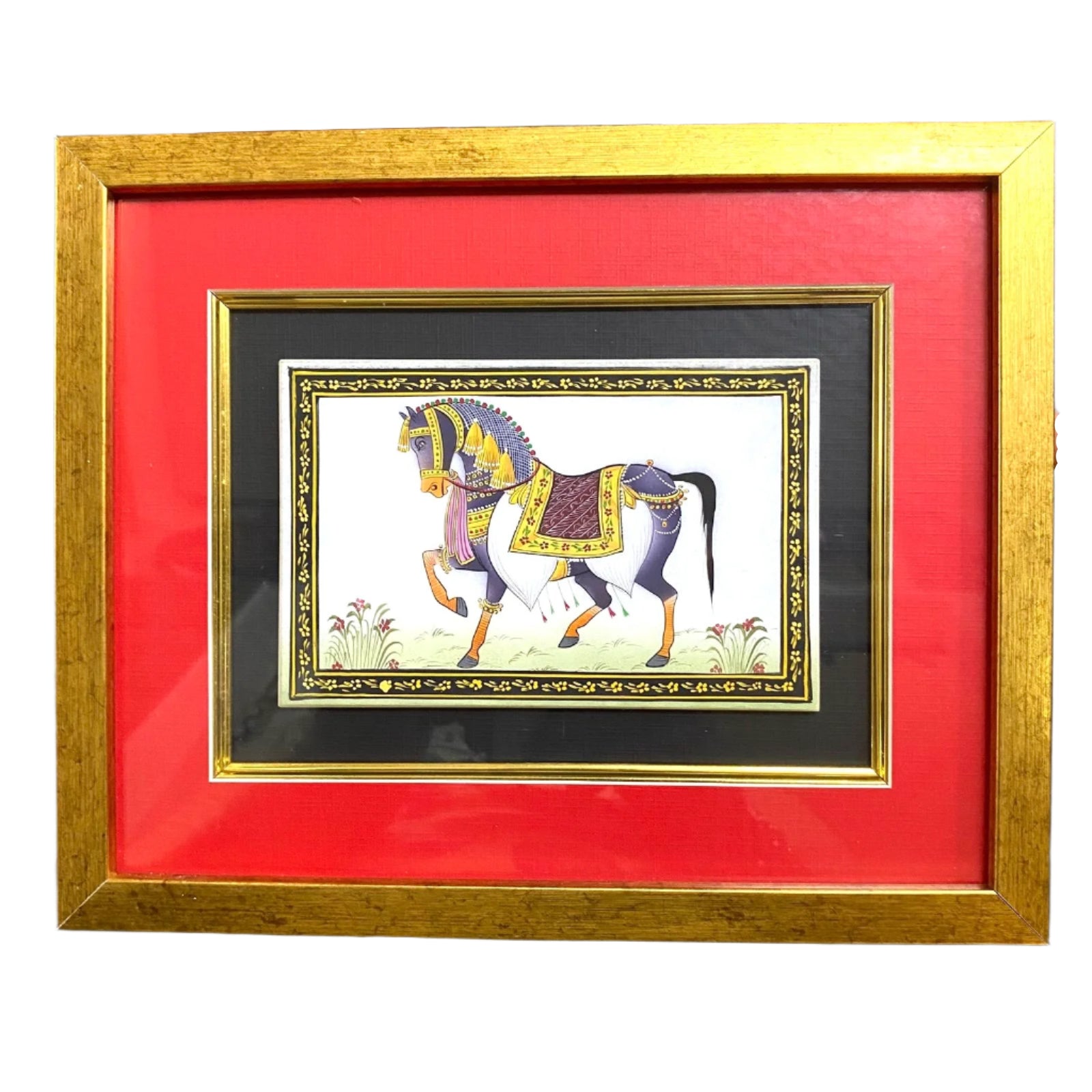 Framed artwork of a horse with a gold frame and red matting.