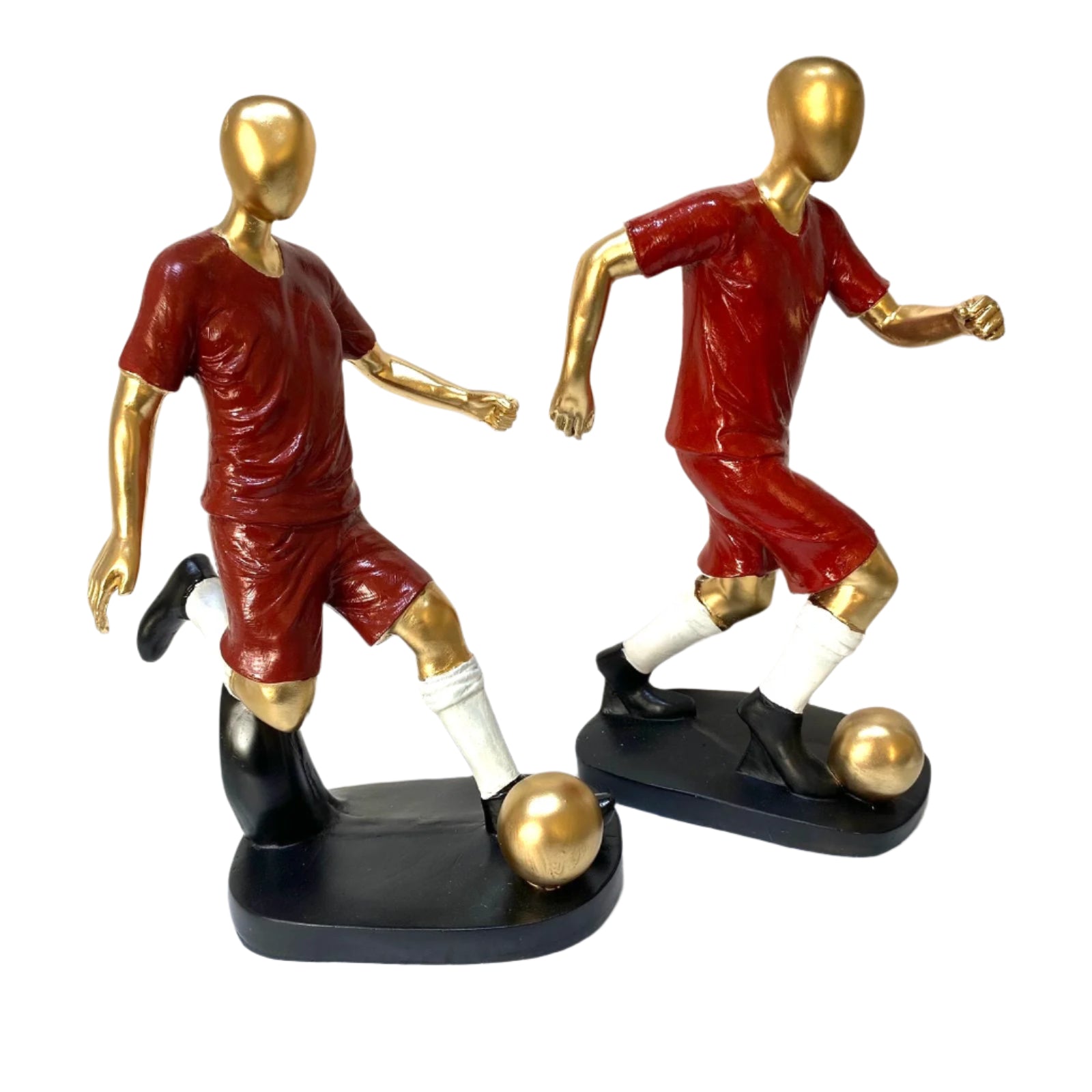 Two mannequin figures in red sports uniforms playing soccer on a white surface.
