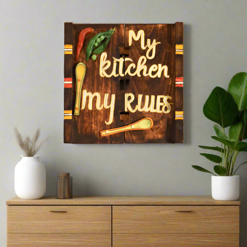 Wooden wall decor with 'My kitchen my rules' text on a beige wall.