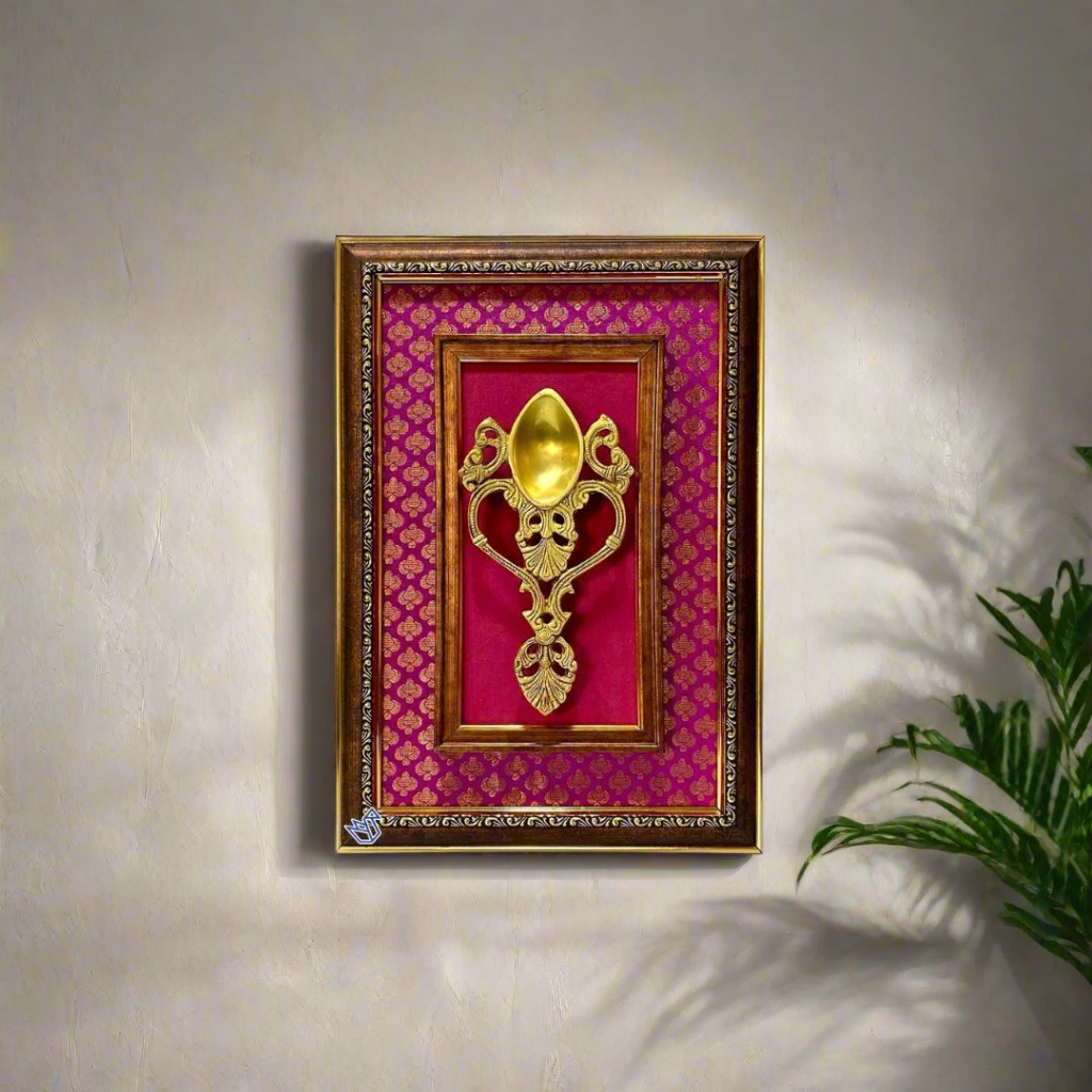 Decorative gold pendant on a red fabric background with a gold frame