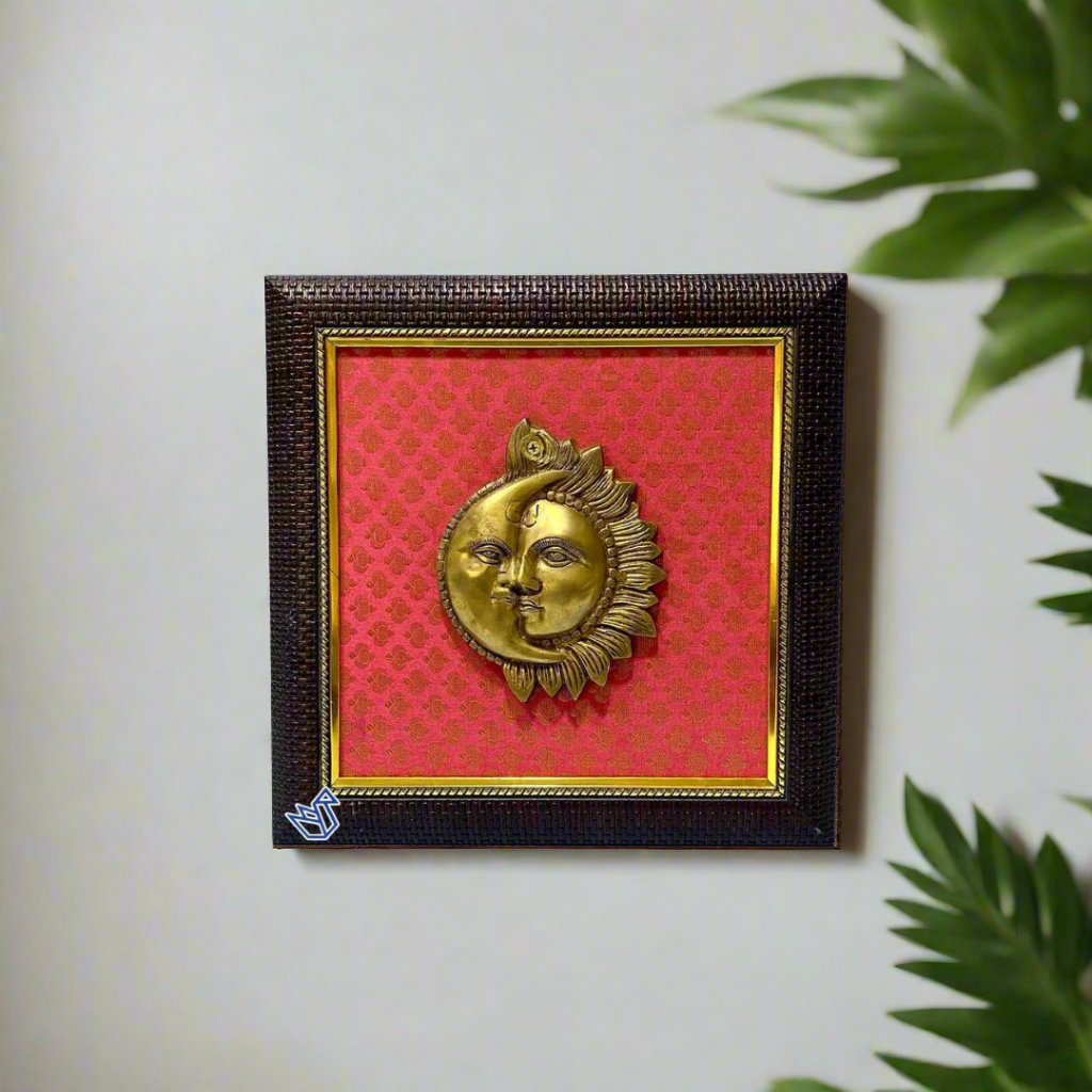 Decorative wall art with a gold moon and sun design on a red background, framed in black.