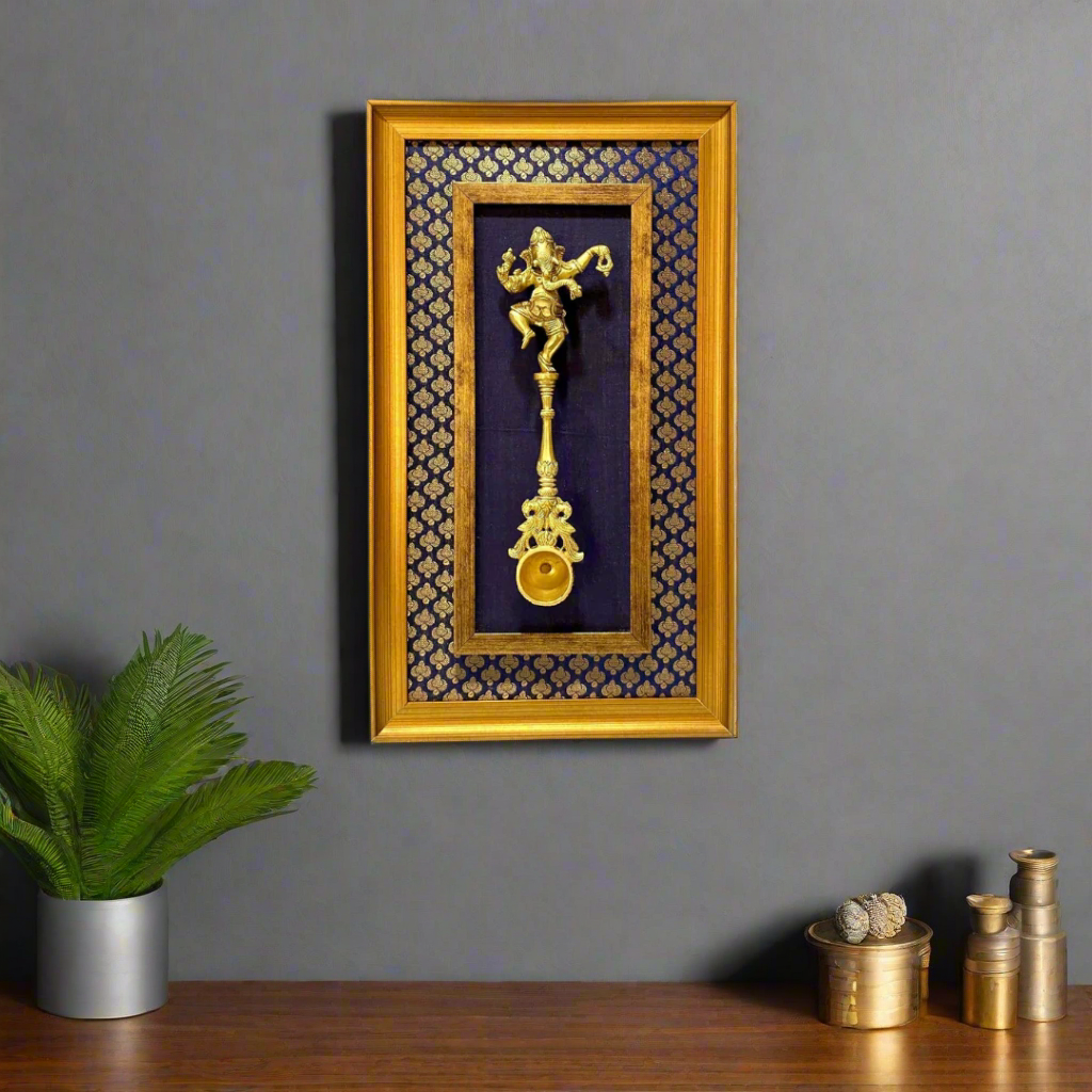 Decorative wall art with gold figurine and patterns in a wooden frame on a white background