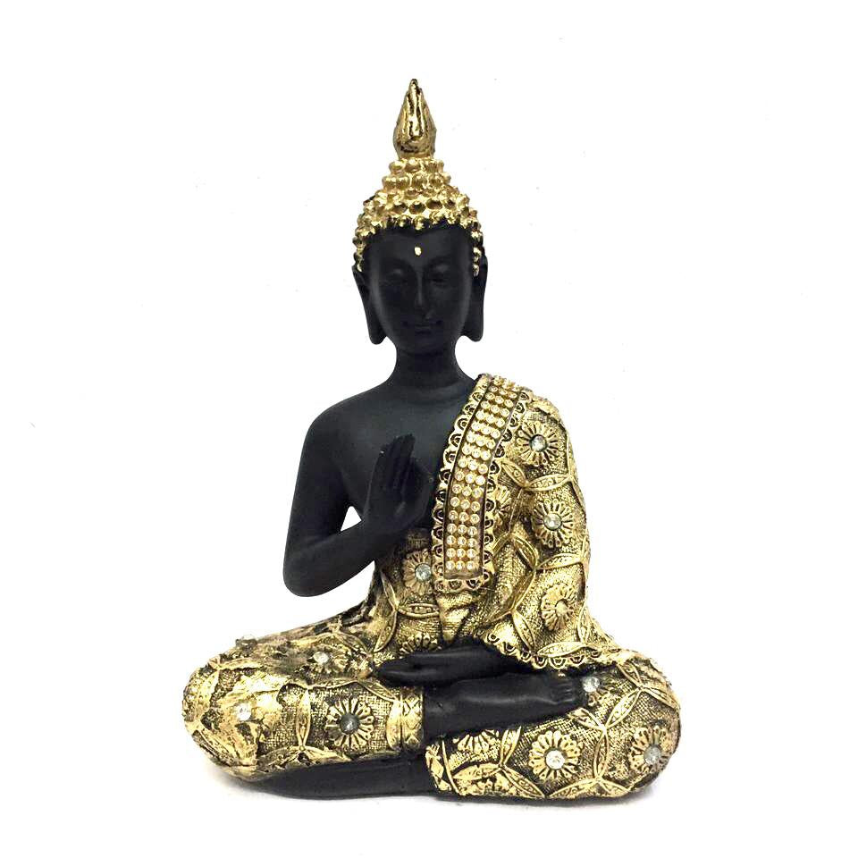 A sculpture of the Buddha with a black body and gold-colored robes and headpiece, sitting in a meditative pose.