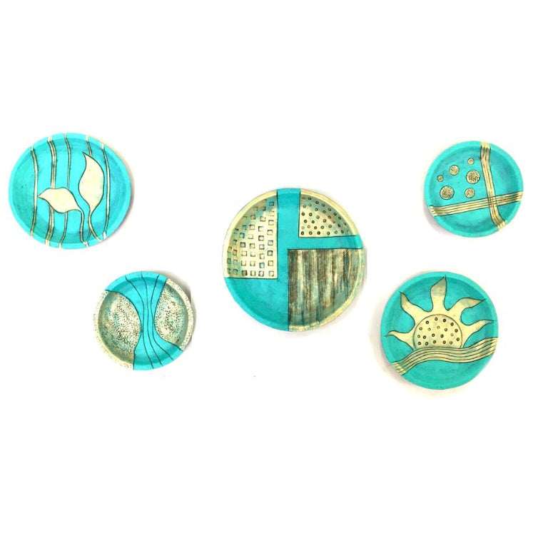 A set of five terracotta clay wall plates with a range of blue and green patterns and designs, displayed against a white background.