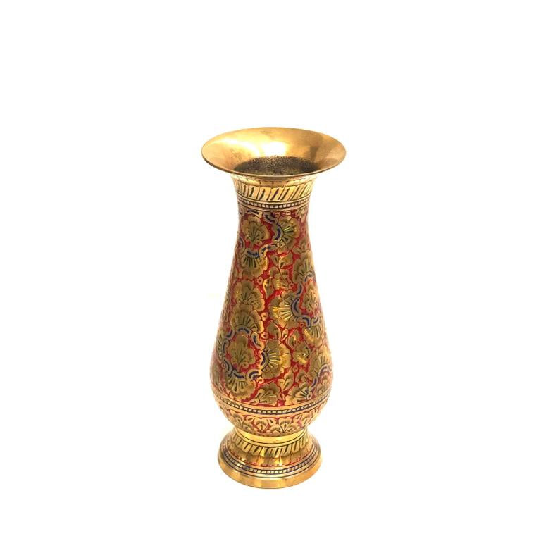 A brass engraved inlay work ancient handcrafted flower vase with a gold-colored top and red body, featuring intricate floral patterns.