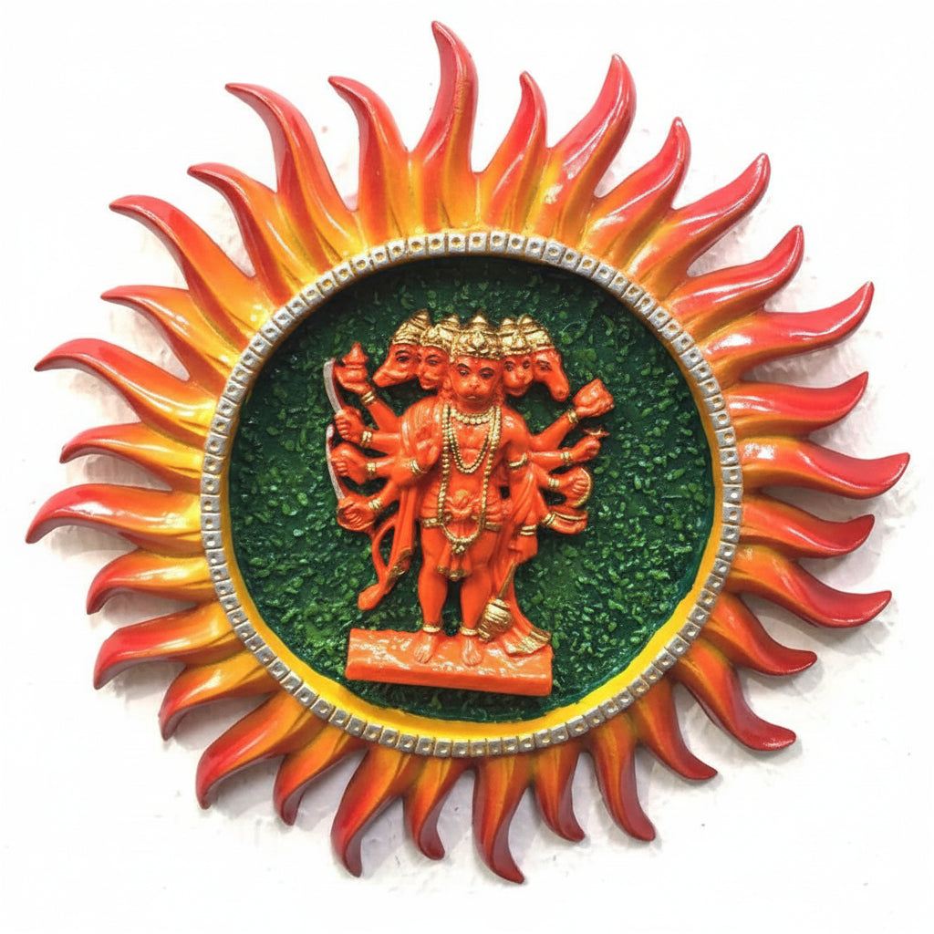 A hanging decoration featuring a sun with multiple arms and a figure resembling a deity, enclosed in a red and orange design with green and yellow details, adorned with small red and orange beads.