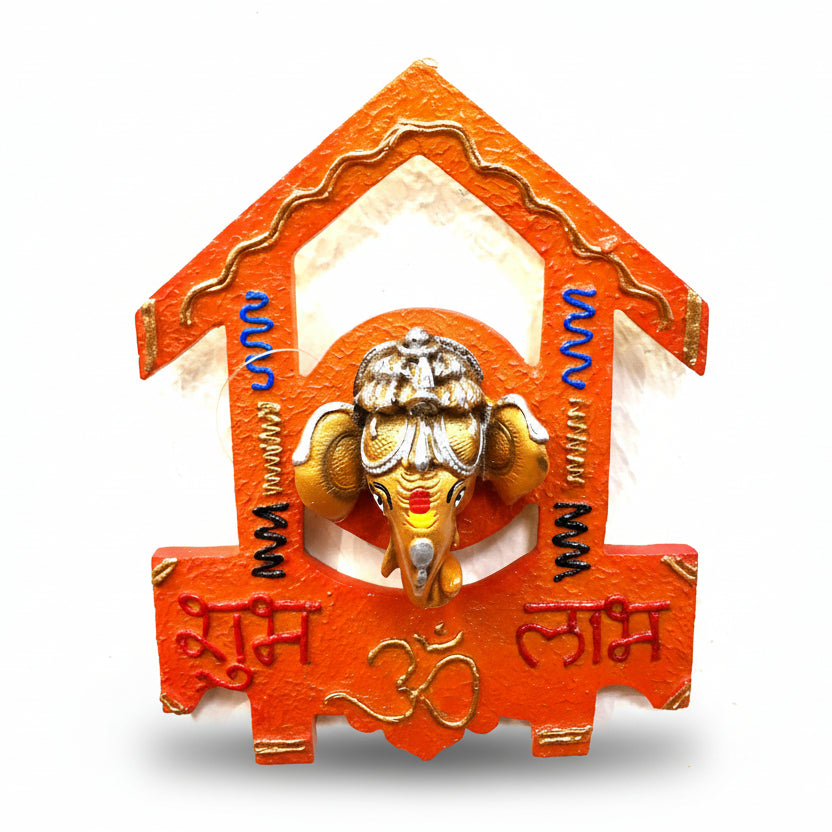 A hanging resin sculpture of Ganesha in an orange and gold frame, with script in Devanagari.