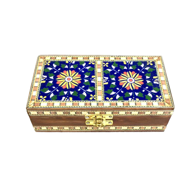 A wooden storage box with blue pottery tile lids in various shades, featuring geometric and floral designs.