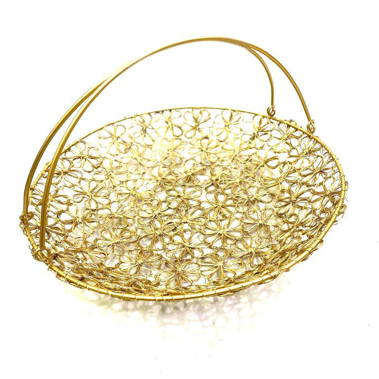A gold-colored metal wire crochet basket with a floral pattern and handles.