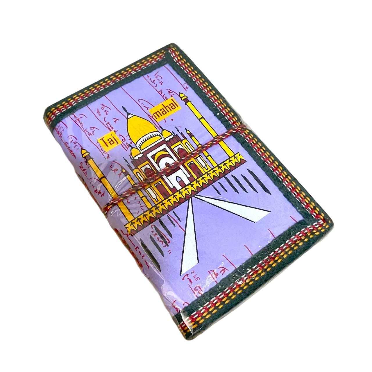 A handmade leather journal featuring a colorful illustration of the Taj Mahal on a lavender background with red script, wrapped with twine and resting on a light wood surface.