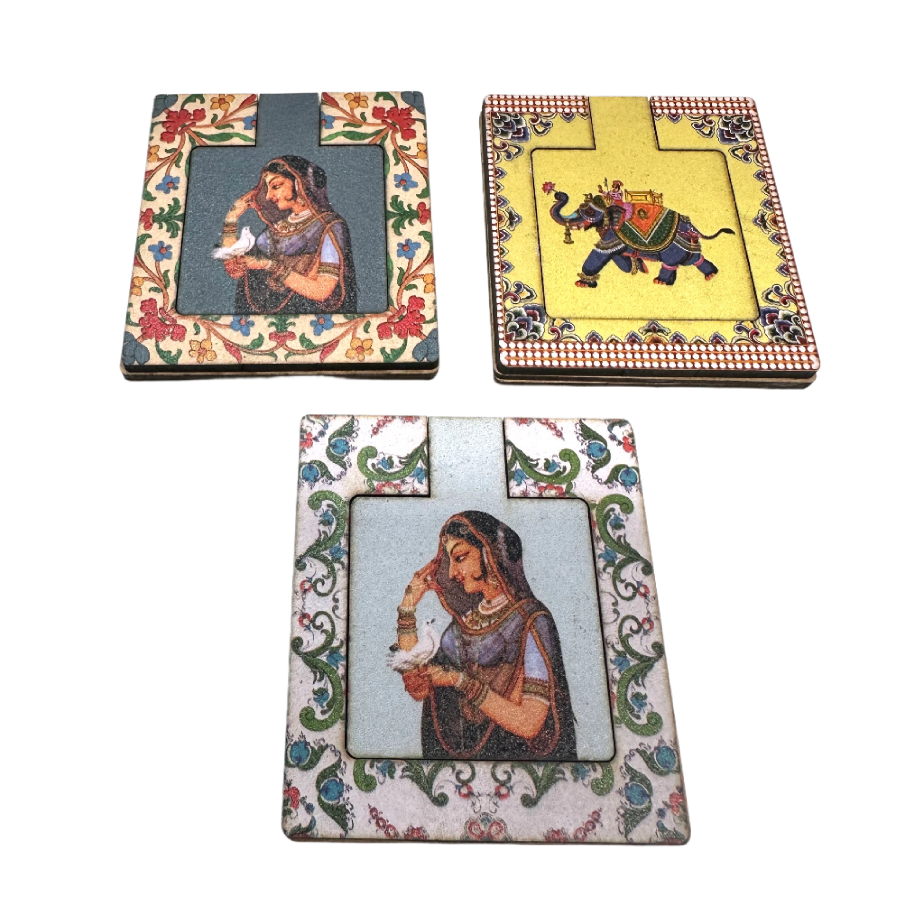 Three decorative coasters with artistic designs on a white surface
