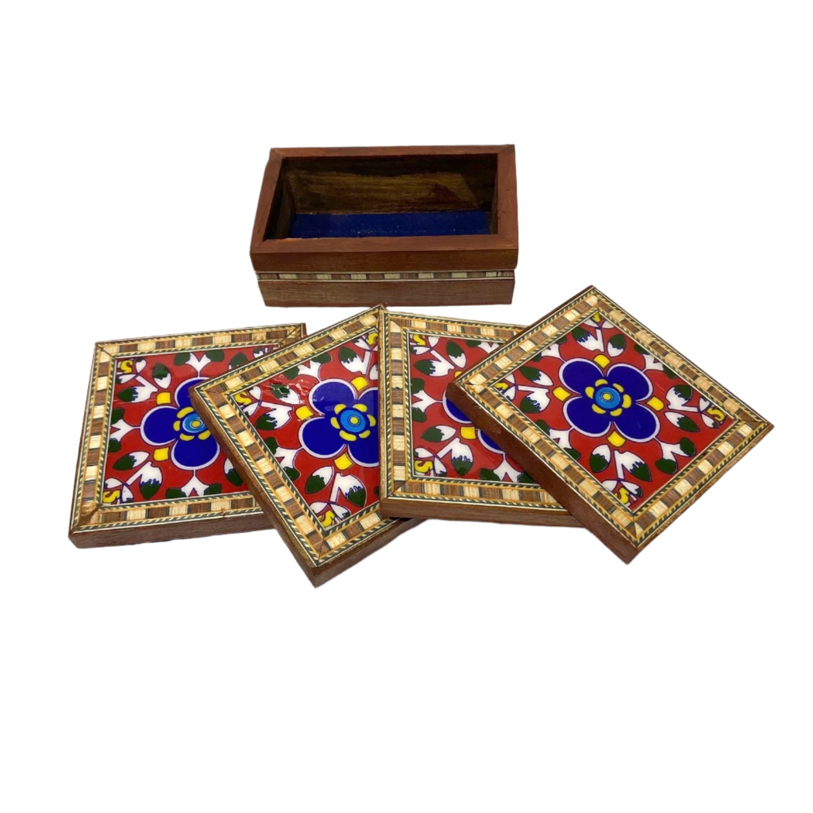 Set of four decorative coasters with floral patterns in a wooden box on a white background